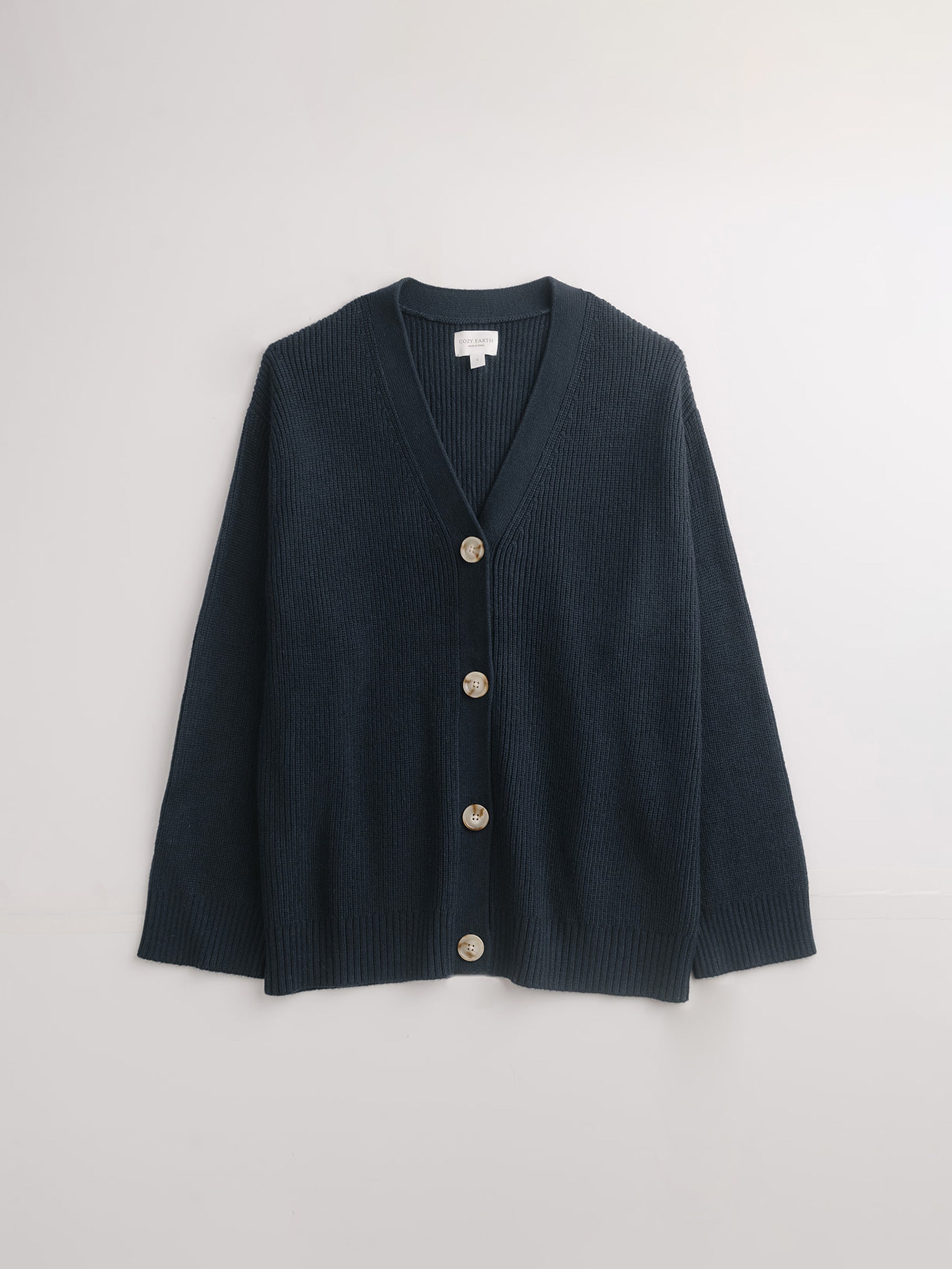 Flat lay of eclipse cardigan with white background 
