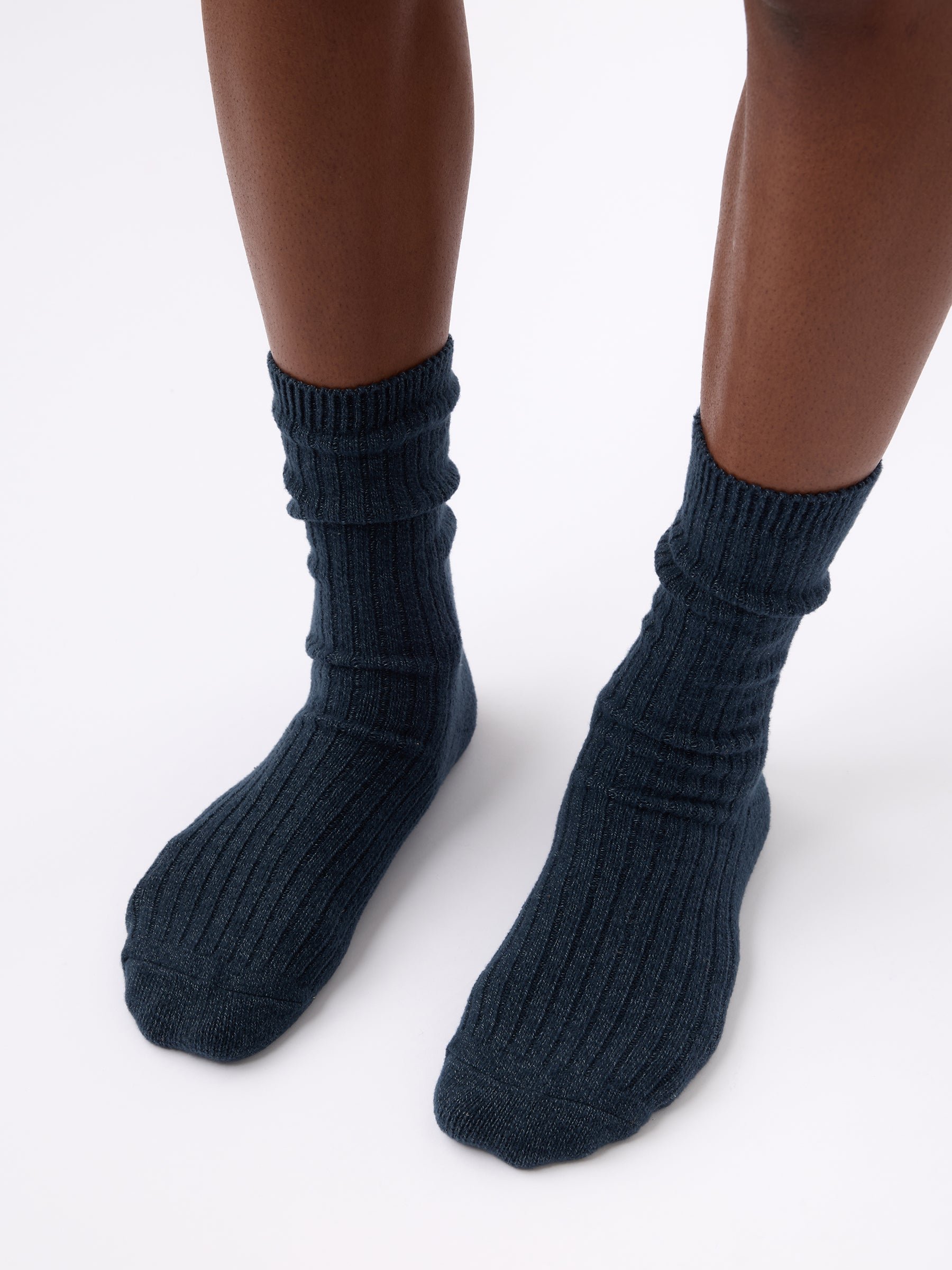 Person wearing Cozy Earth Plush Lounge Sock in Eclipse 