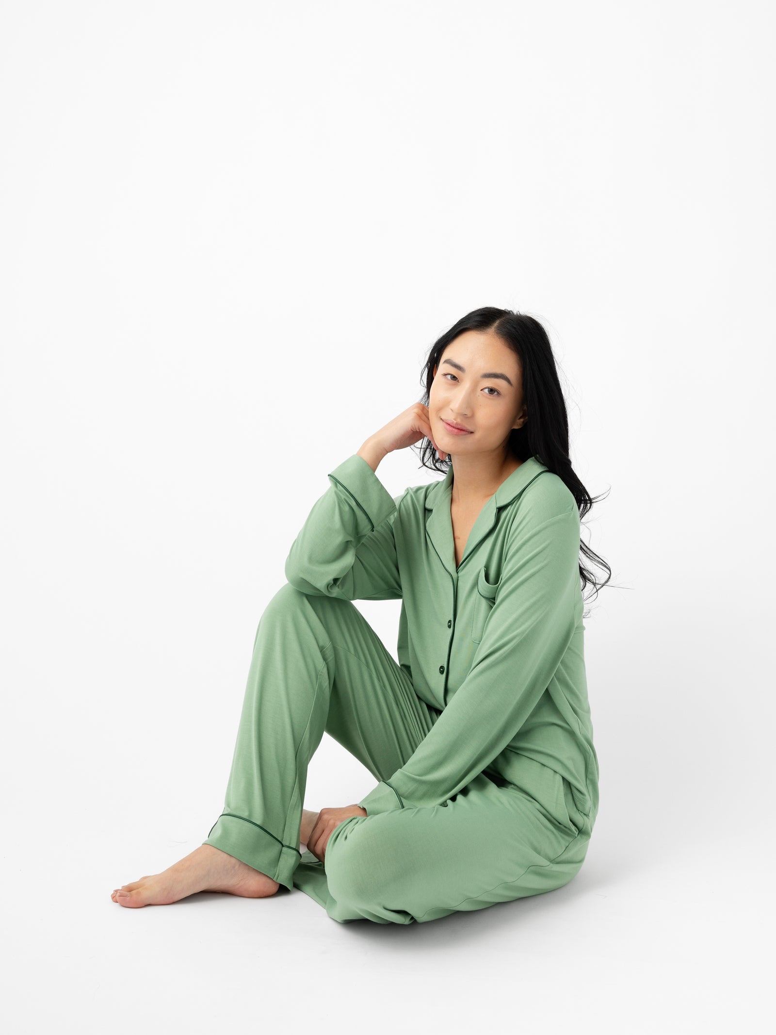 Woman seated wearing Women's Long Sleeve Bamboo Pajama Top in Stretch-Knit - Fern 