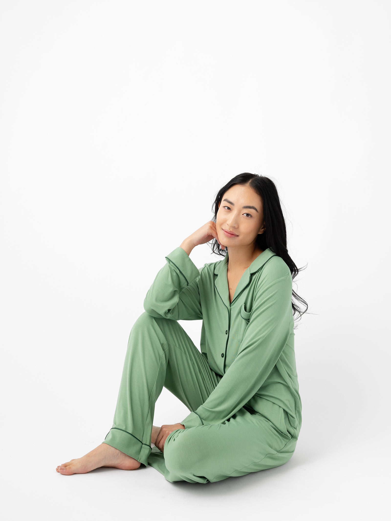 Seated woman wearing Women's Stretch-Knit Bamboo Pajama Pant in Fern 