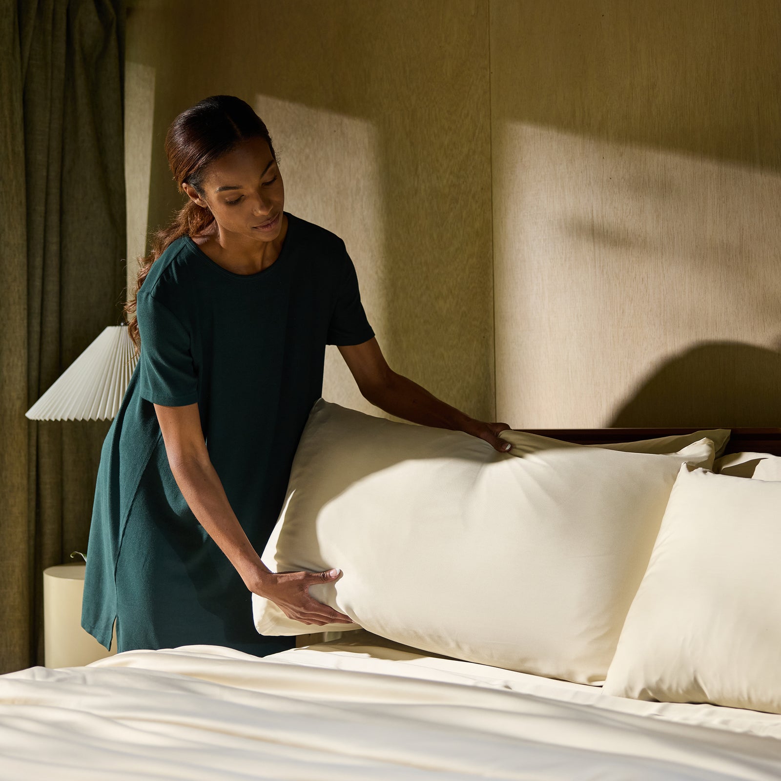 Woman making bed with flax bedding standard/king/body