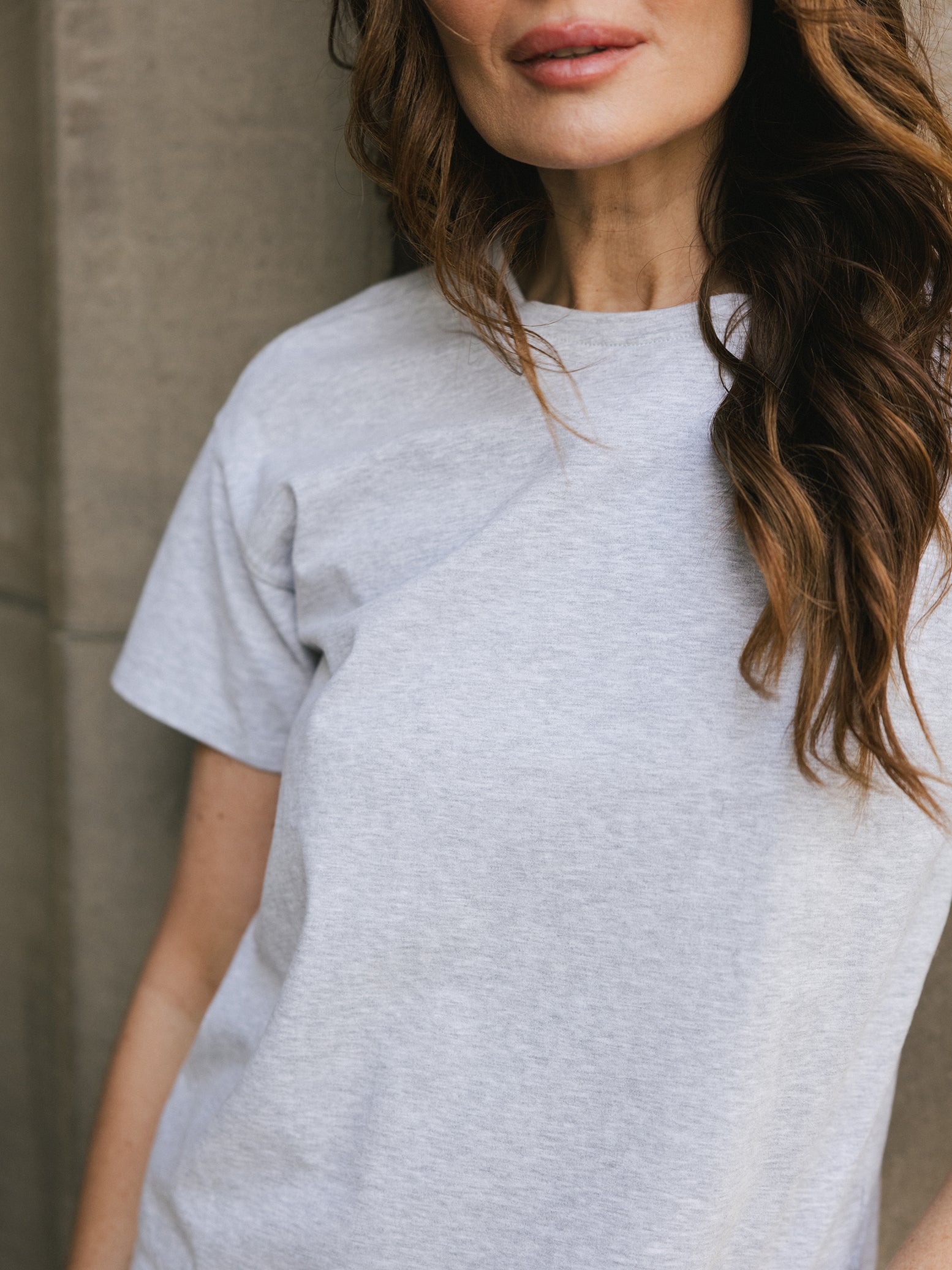 Close up of woman wearing french dove heather tee outside 