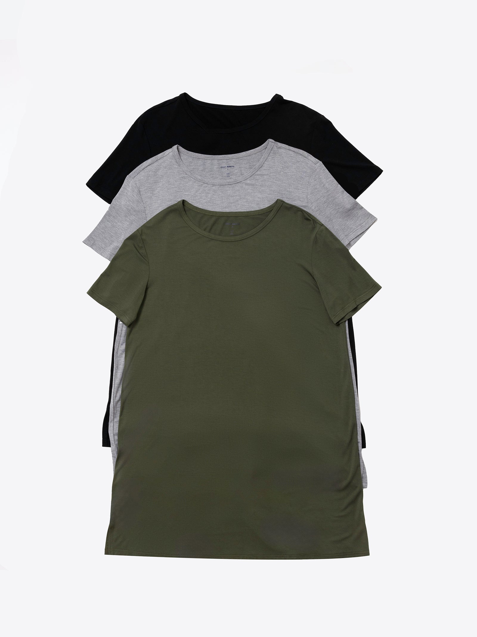 Three plain **Women's Bamboo Stretch Knit Sleep Dresses** from **Cozy Earth** are laid out in a staggered stack: the top dress is olive green, the middle is gray, and the bottom is black. The background is white. 