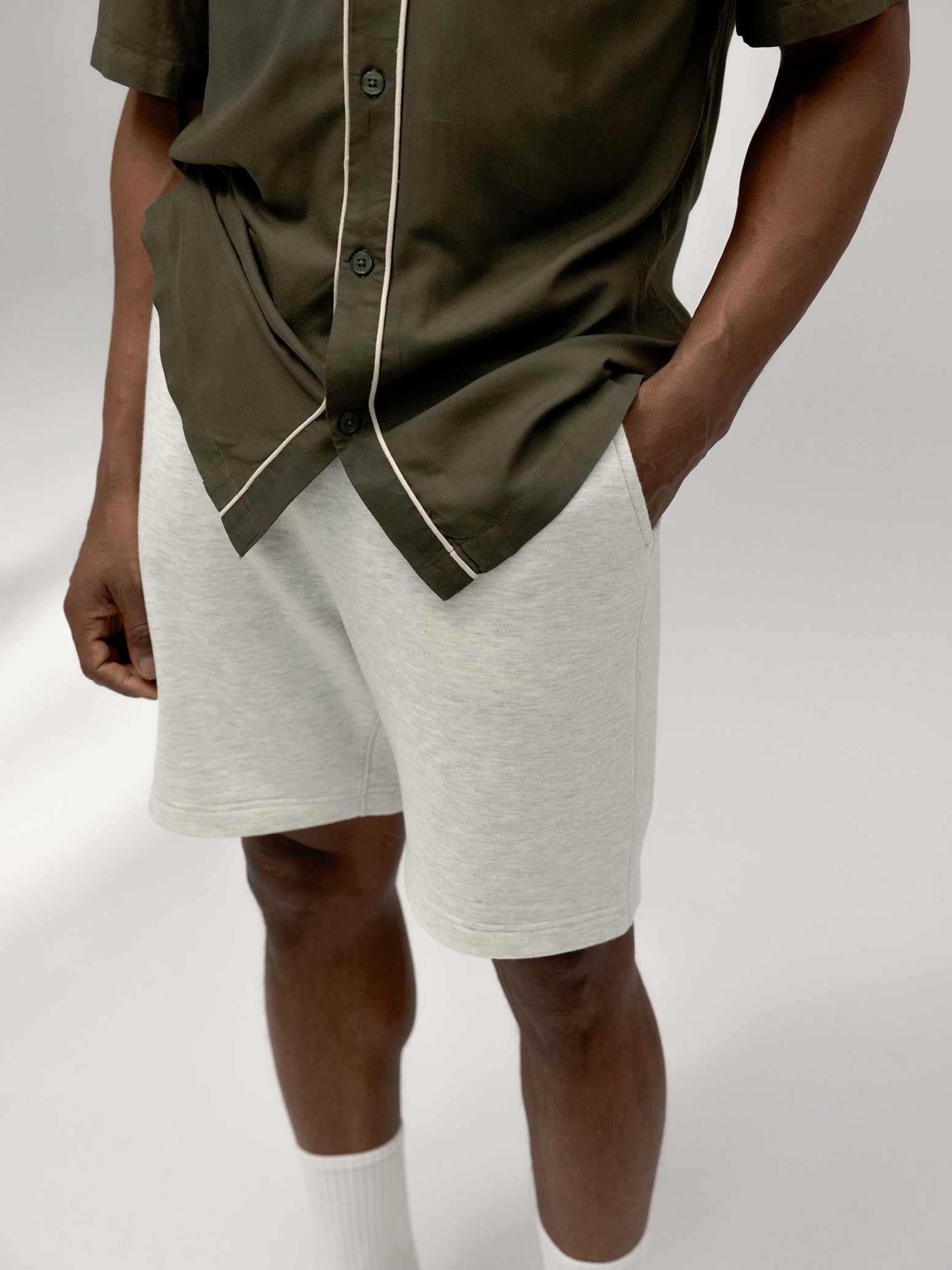 Close up of man wearing heather grey cityscape shorts 