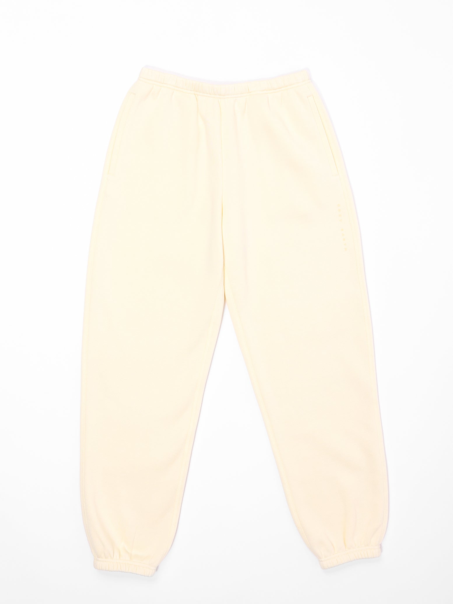 The Women's CityScape Sweatpants by Cozy Earth, shown on a white background, are light yellow with an elastic waistband and cuffs. They feature side pockets and offer a loose fit. 