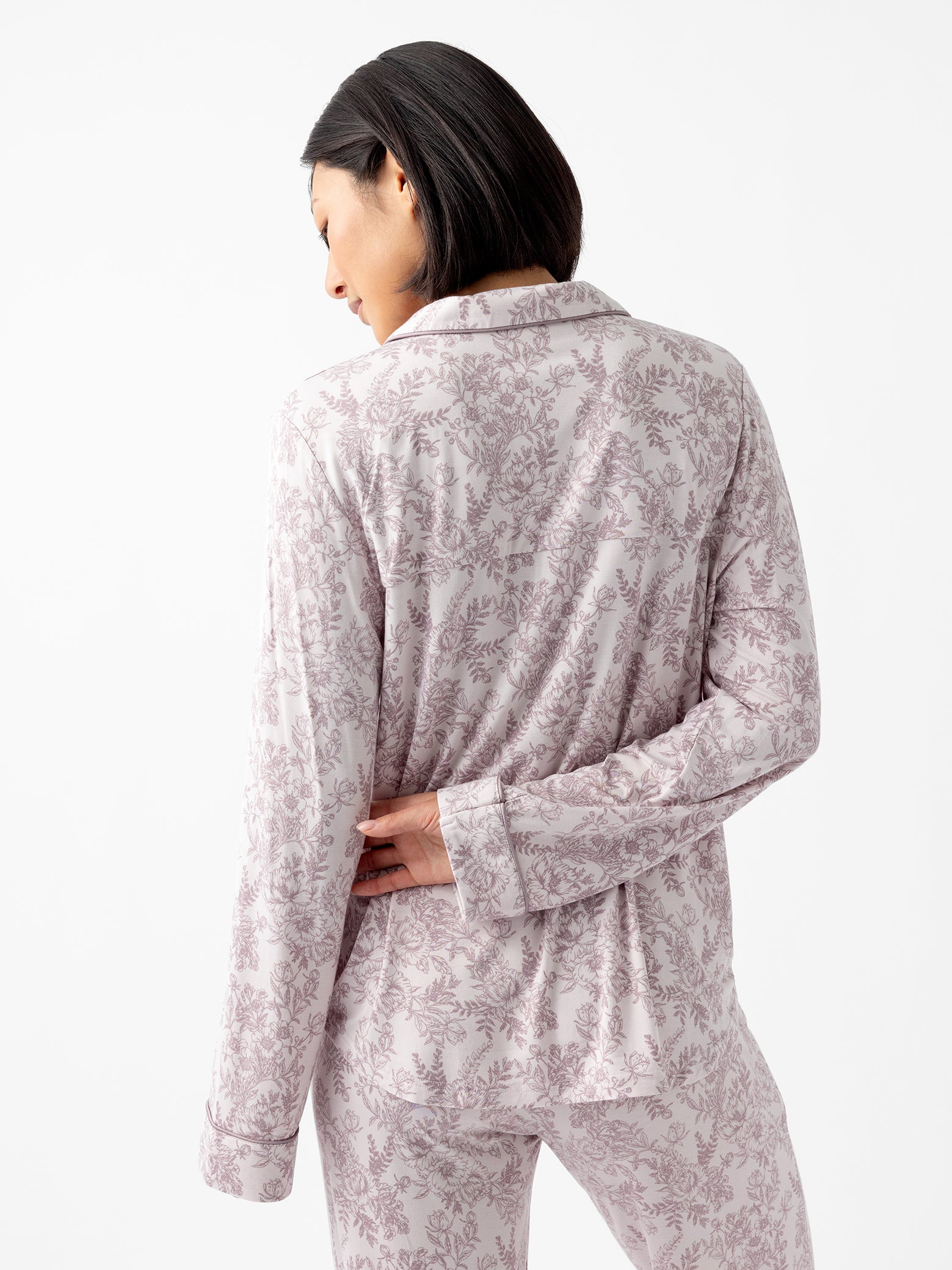 Back of woman wearing lilac toile pajama shirt 
