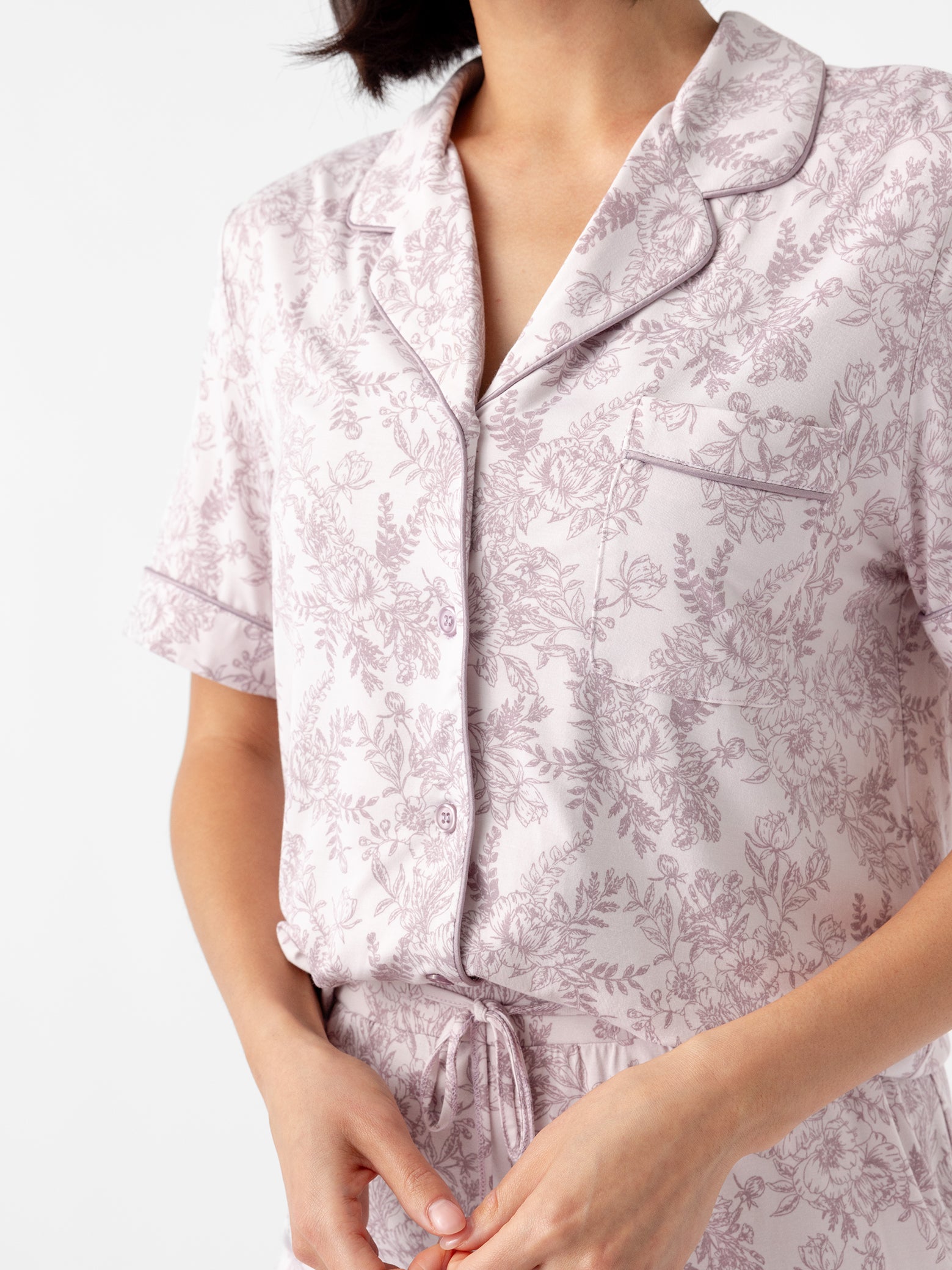 Close up of woman wearing lilac toile short sleeve pajama top 