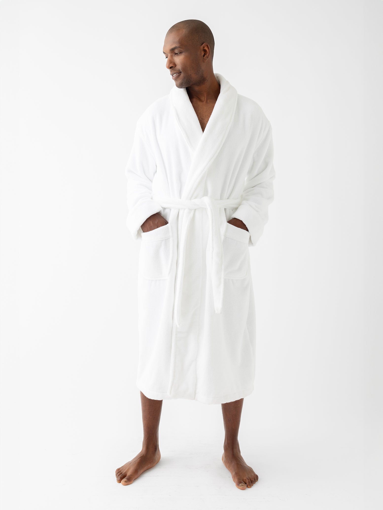 Man in white bath robe with white background 