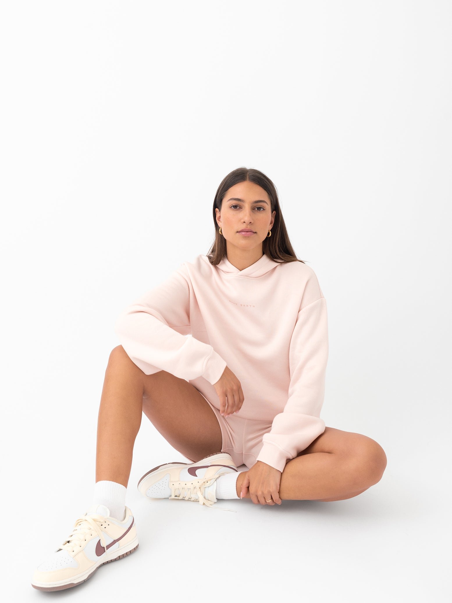 Peony CityScape Shorts. The shorts are being worn by a female model in casual shoes. The background it a white background. 