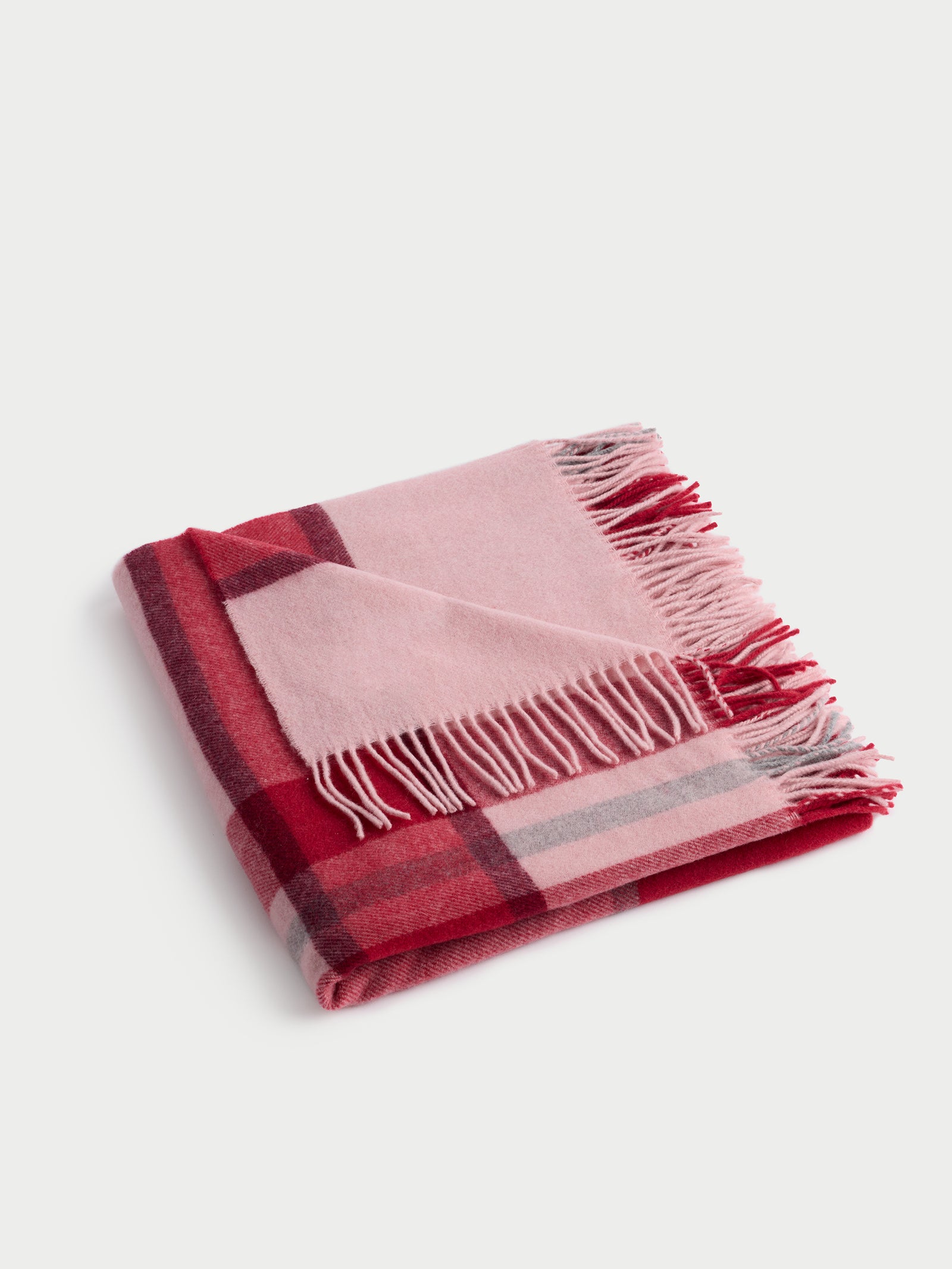 Pink lucca throw folded with white background 