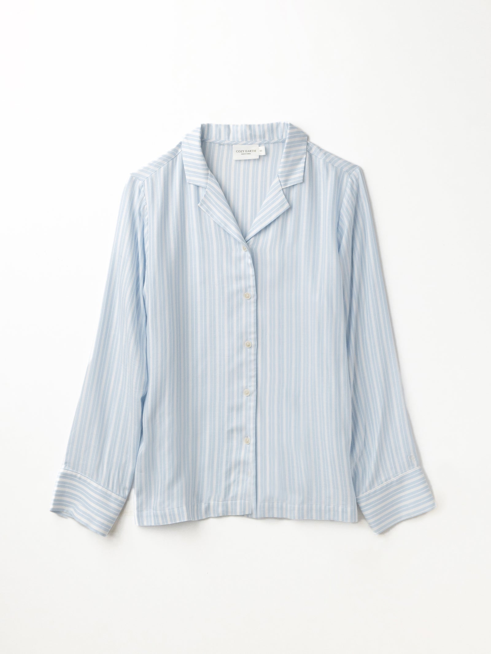 Flat lay of spring blue stripe pajama top with white background 