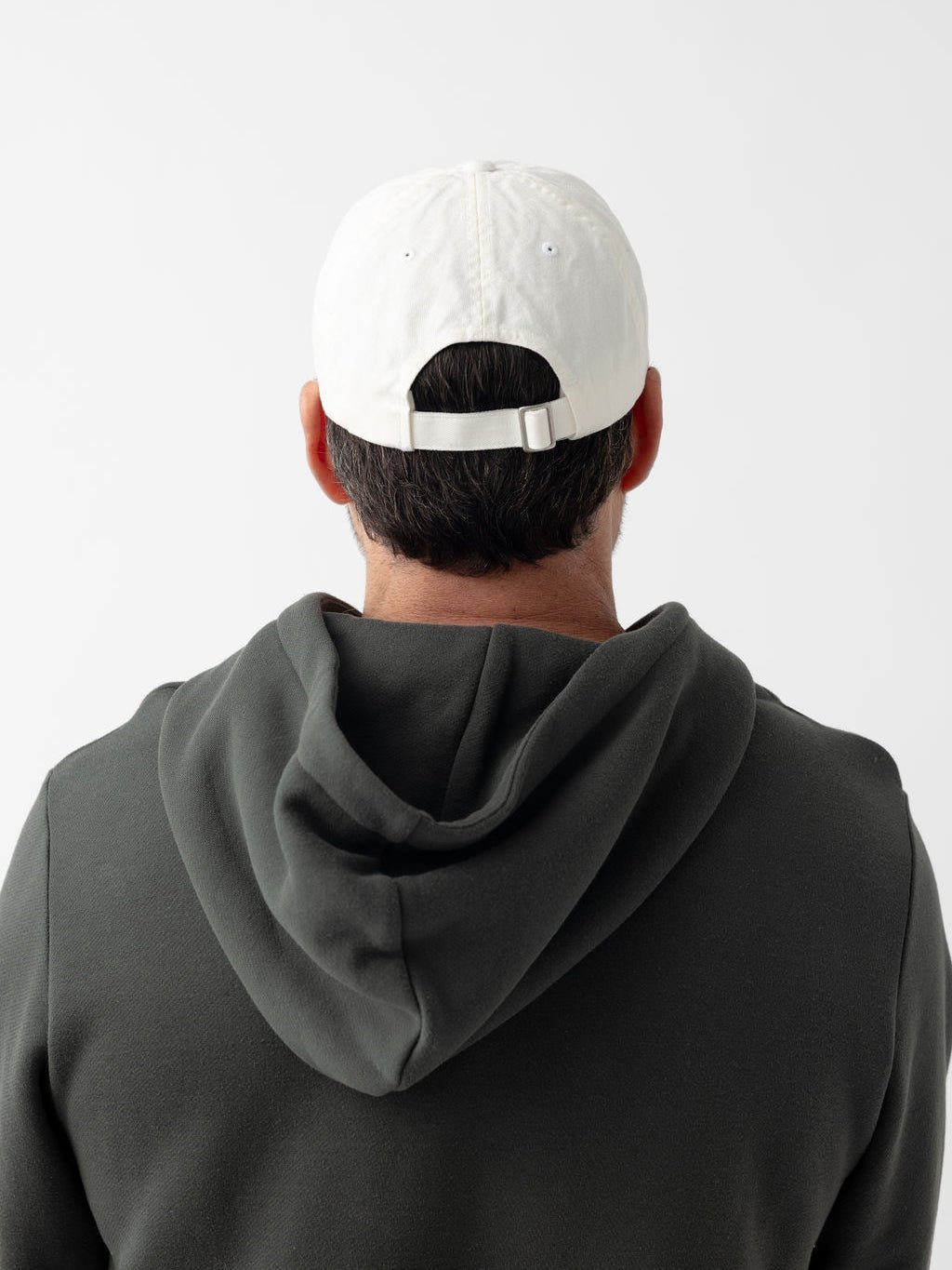 Back of man wearing washed cream vintage cap 