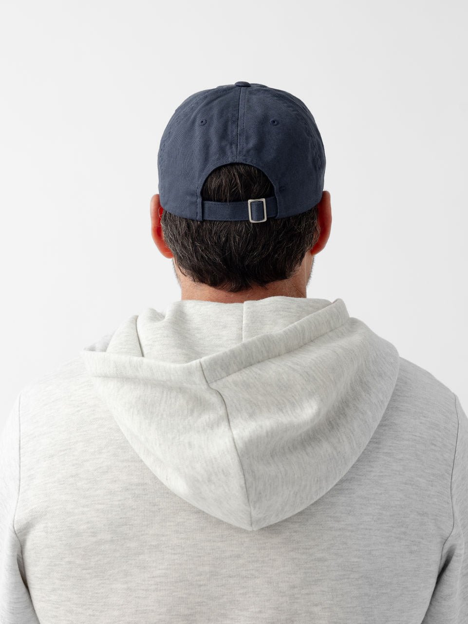 Back of man wearing washed navy vintage cap 