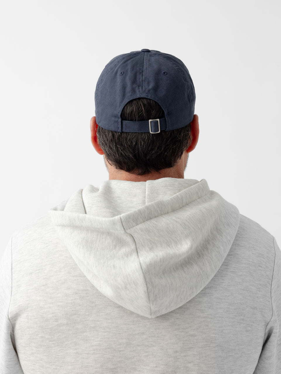Back of man wearing washed navy vintage cap 