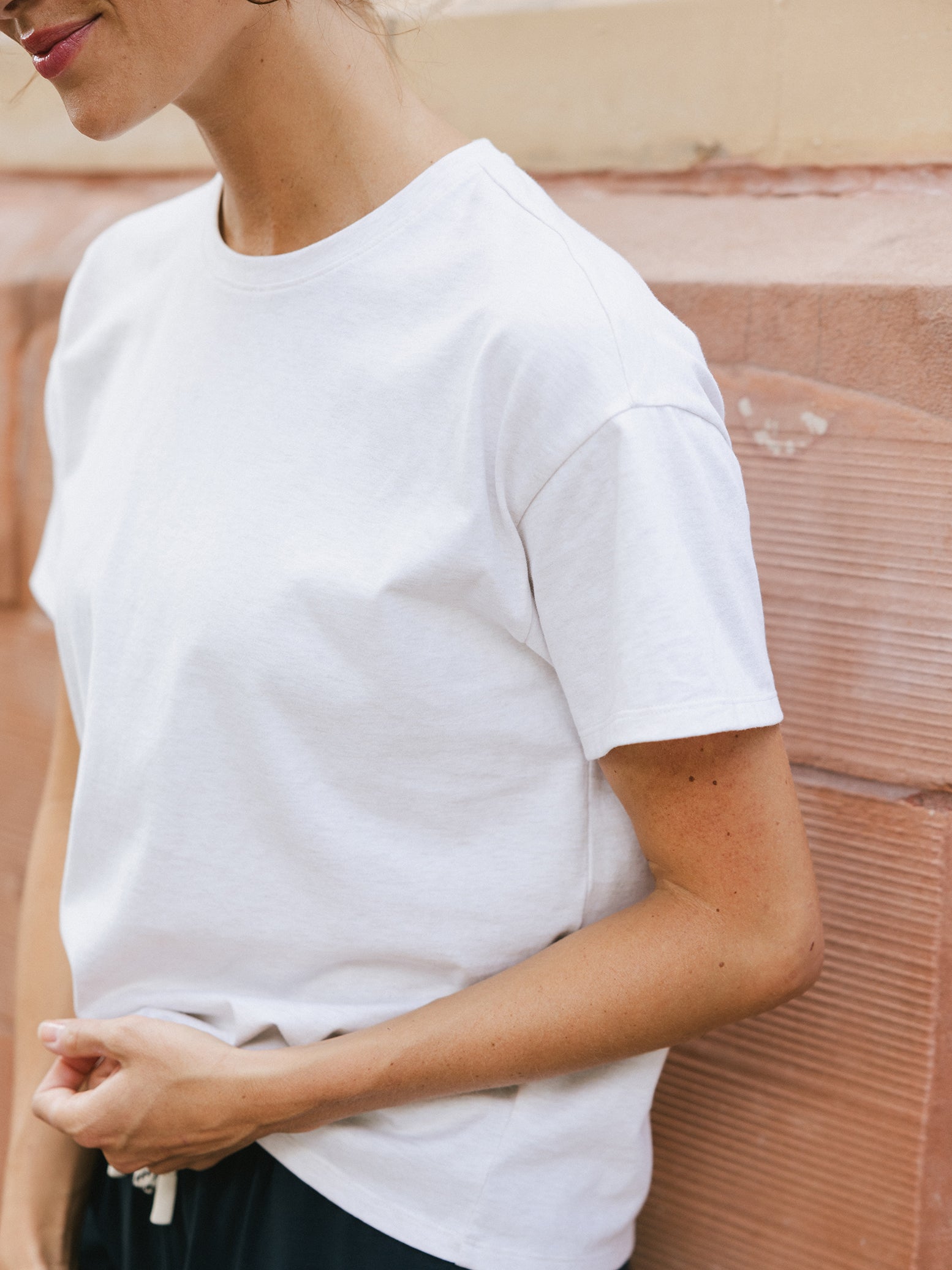 Close up of woman wearing white tee 