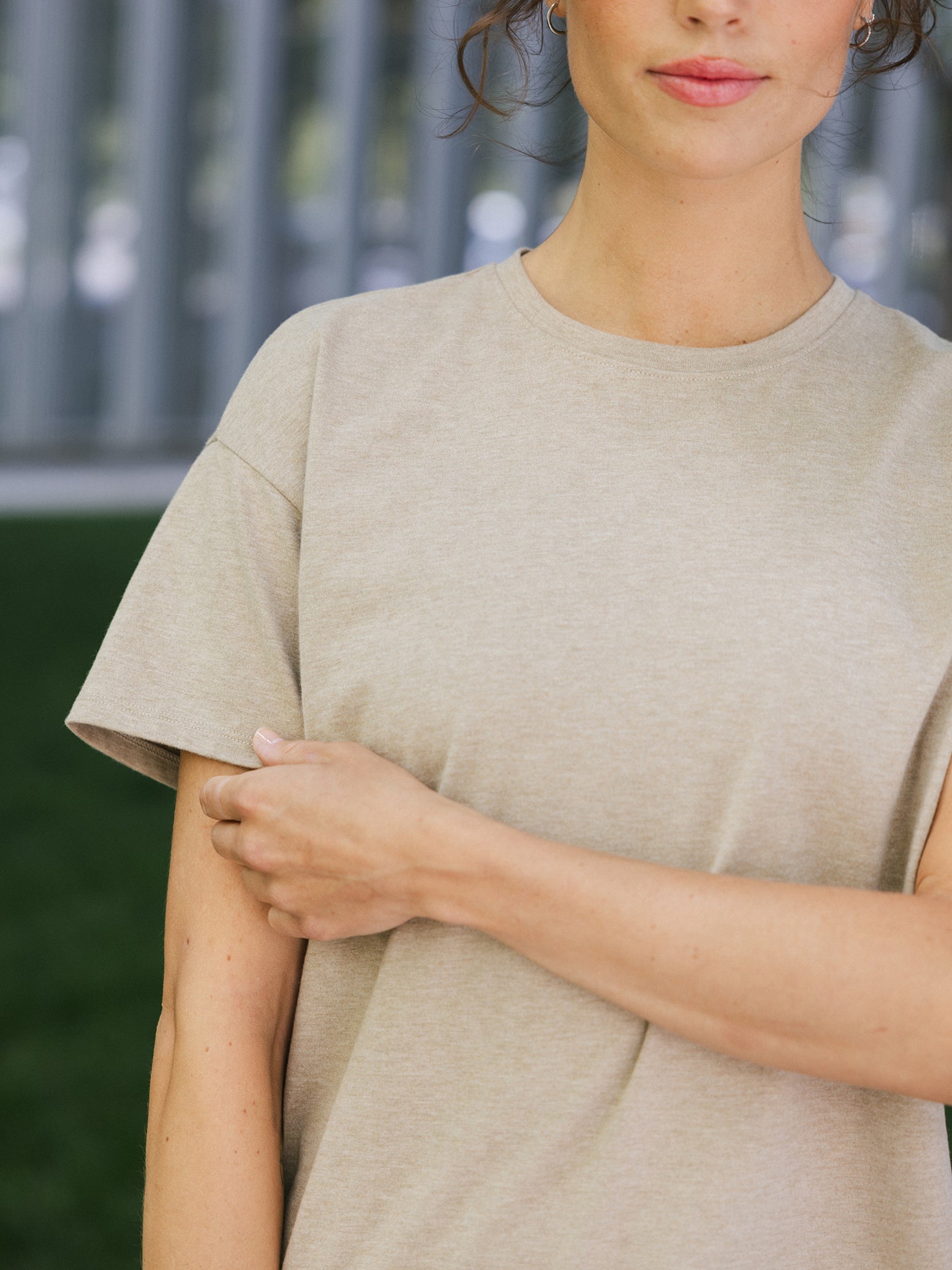 Close up of woman outside wearing beech heather tee 