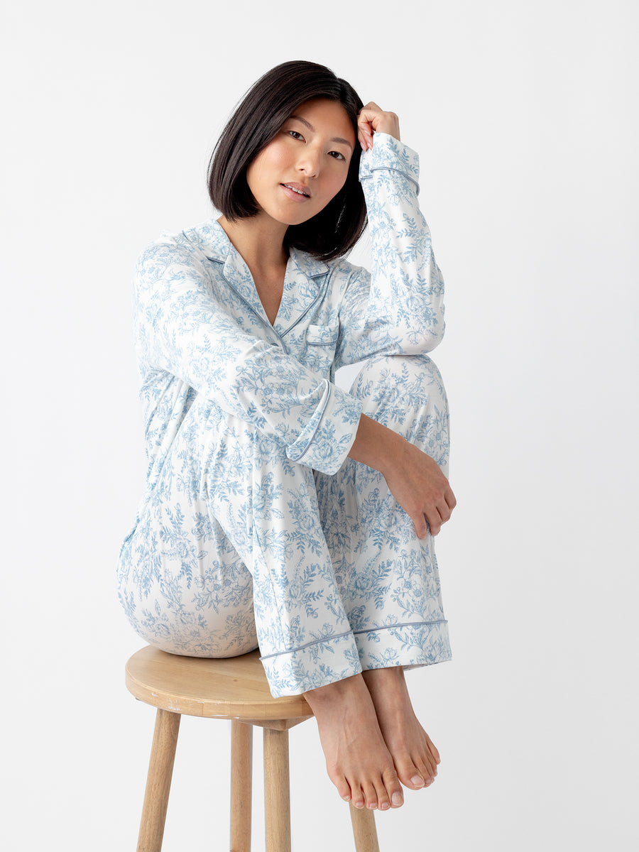 Woman sitting on stool in blue toile pajama set |Color:Blue Toile