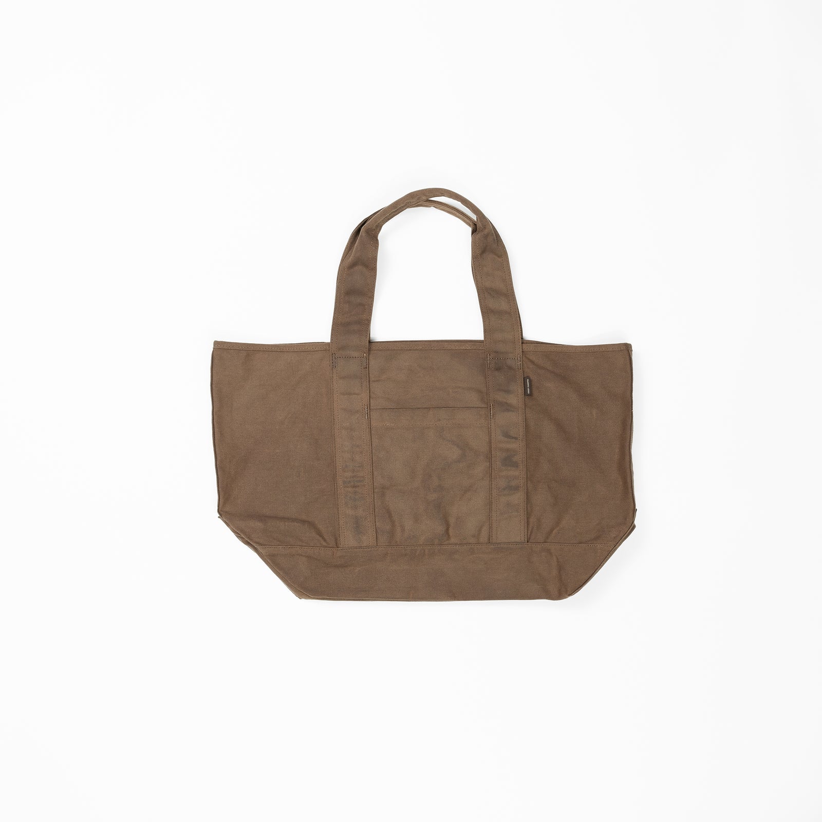 A brown, rectangular Waxed Canvas Tote by Cozy Earth featuring two top handles. The bag boasts a simple, unadorned design and appears sturdy with reinforced stitching along the edges. The fabric of the tote is slightly textured. 