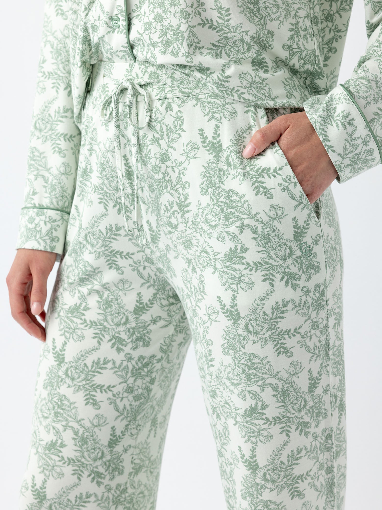 Close up of waist and pocket of celadon toile pajama pants 