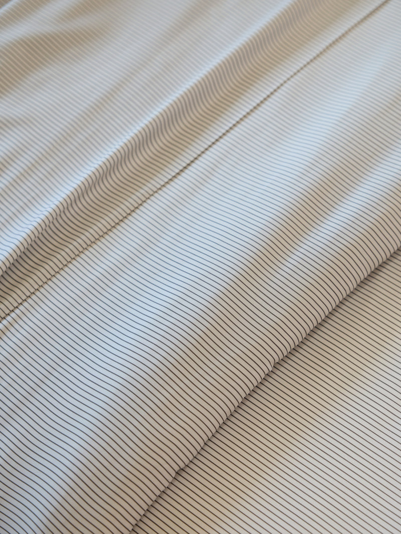 Cozy Earth's Bamboo Duvet Cover features a close-up design of thin, parallel lines that form a striped pattern. These evenly spaced lines create a textured and uniform appearance.