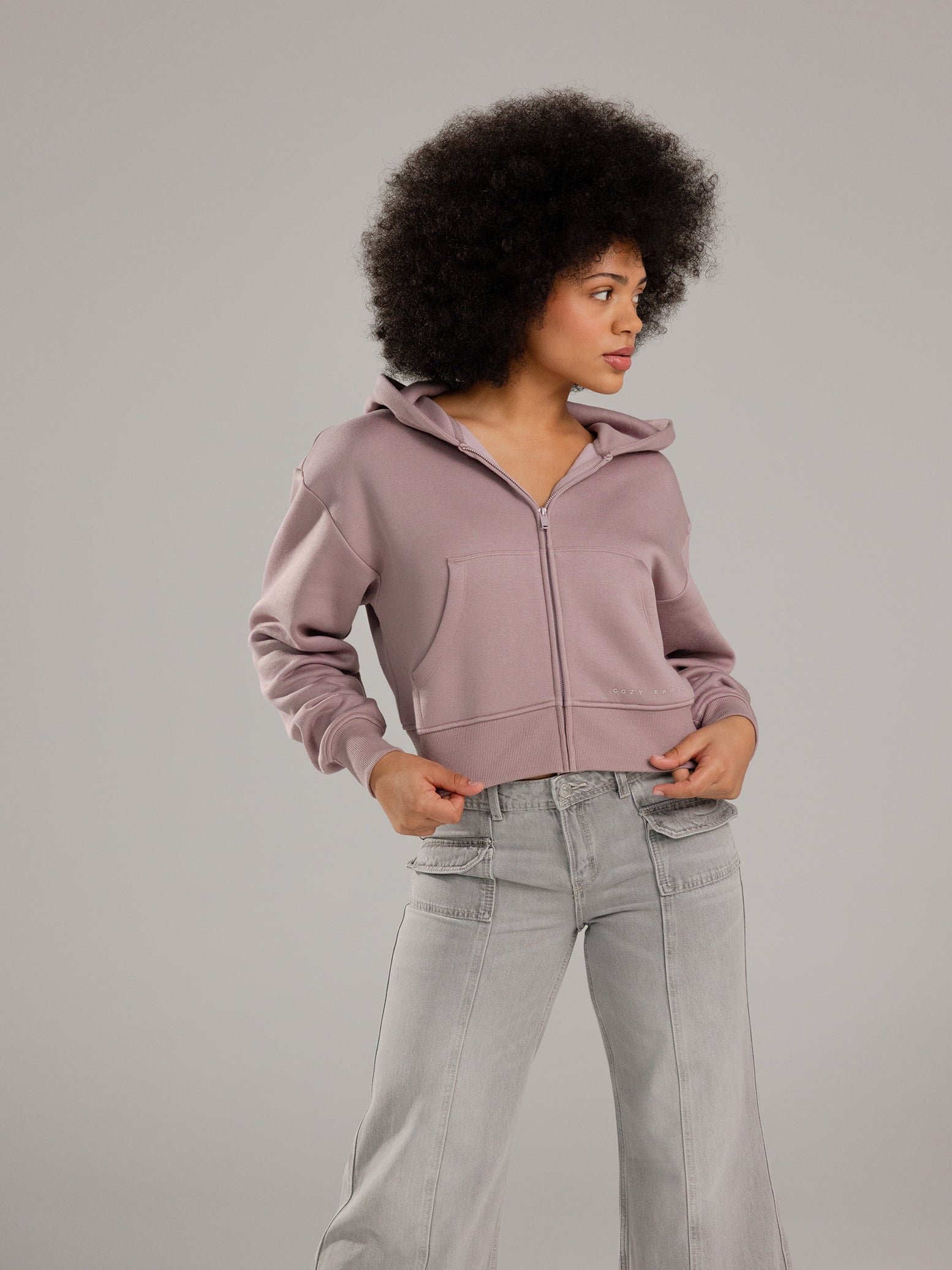 Woman wearing Dusty Orchid CityScape Cropped Full Zip with grey background 