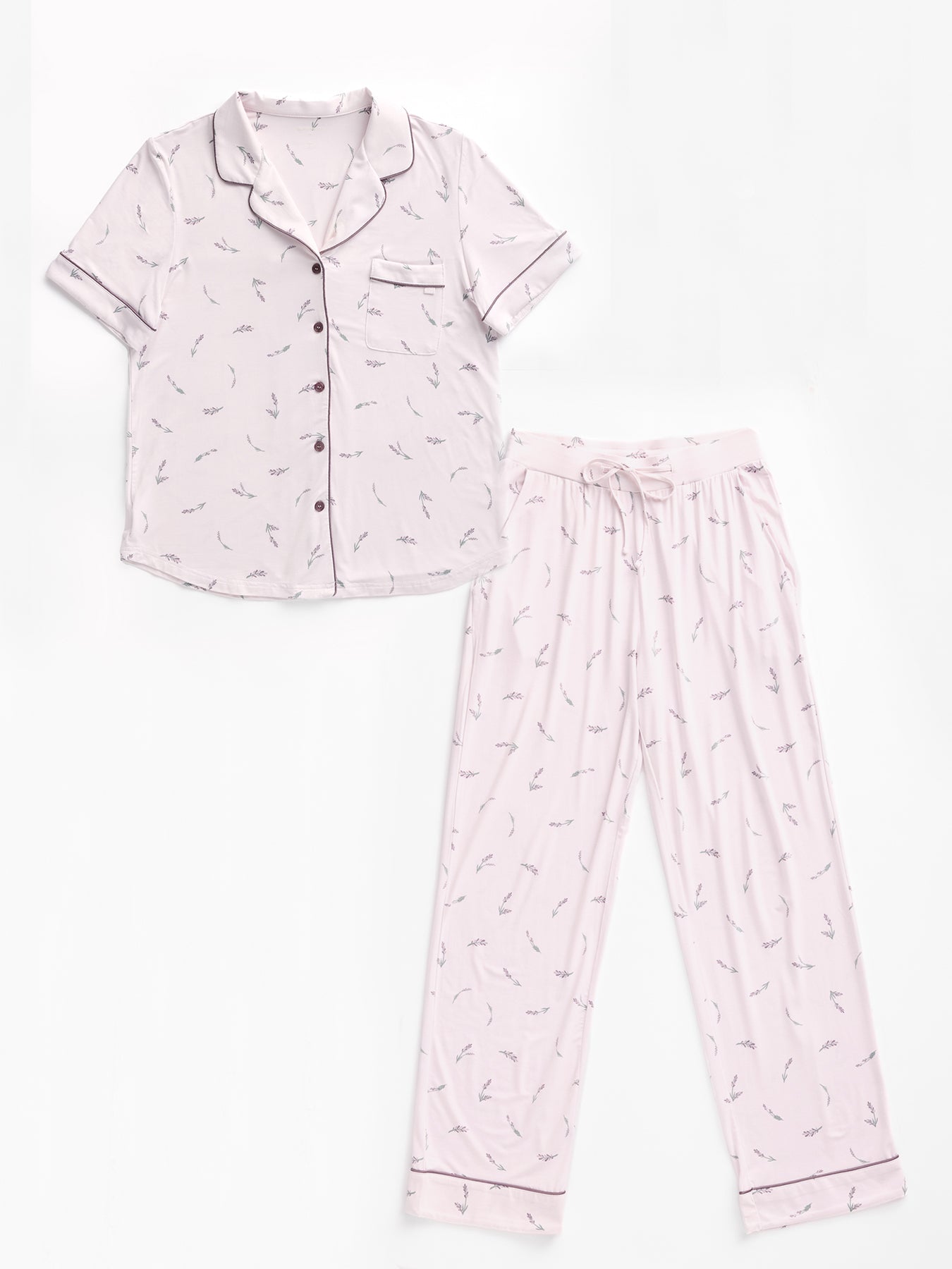 The Women's Bamboo Stretch-Knit Pajama Set by Cozy Earth includes a light pink short-sleeved, button-up top with a small pocket and matching long pants. Both pieces feature a subtle feather print and dark piping. 