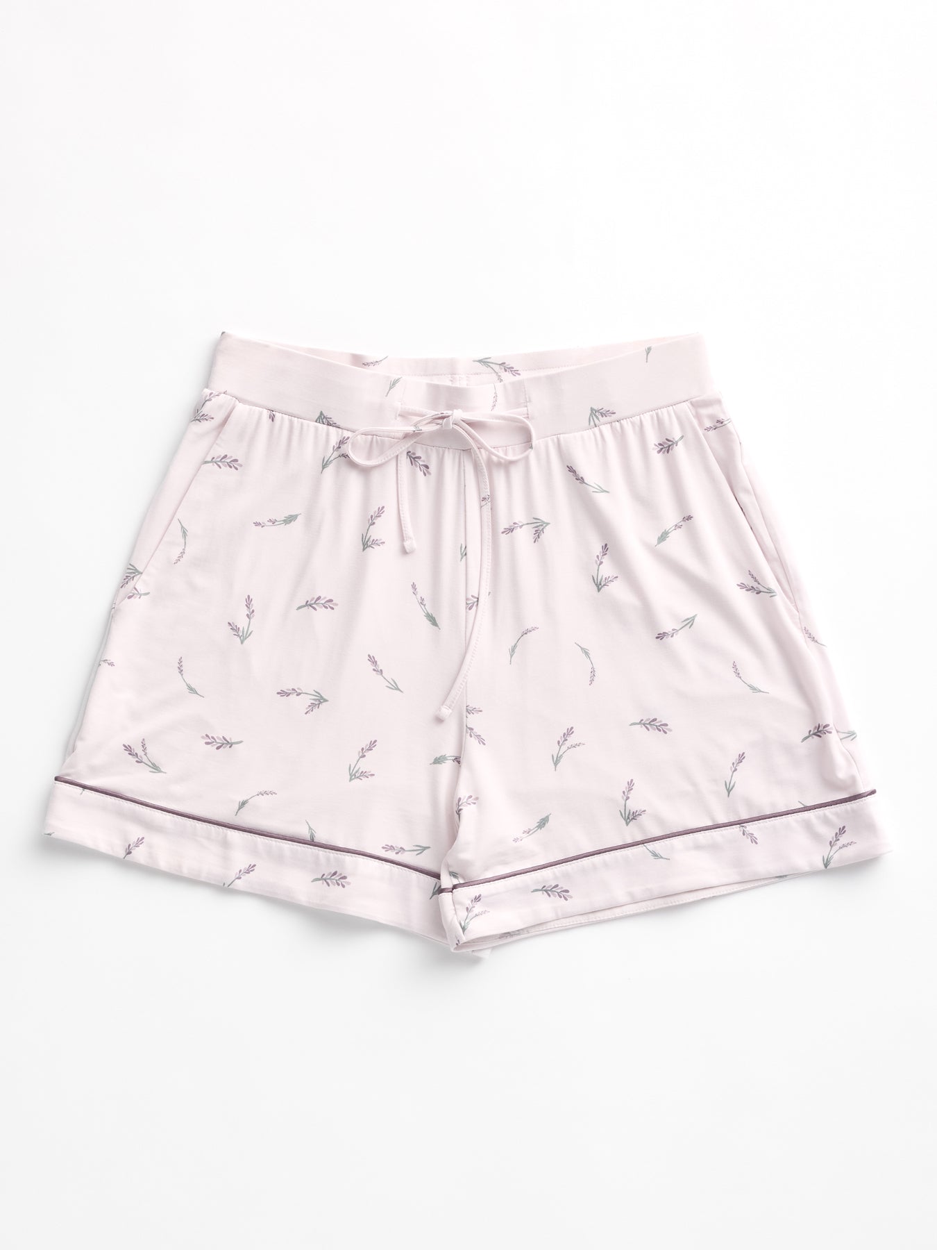 HIDE's Women's Bamboo Stretch-Knit Pajama Short in light pink showcases a subtle floral pattern with lavender and small sprigs. Featuring a drawstring waist and folded hem, they are displayed laid flat on a white background. 