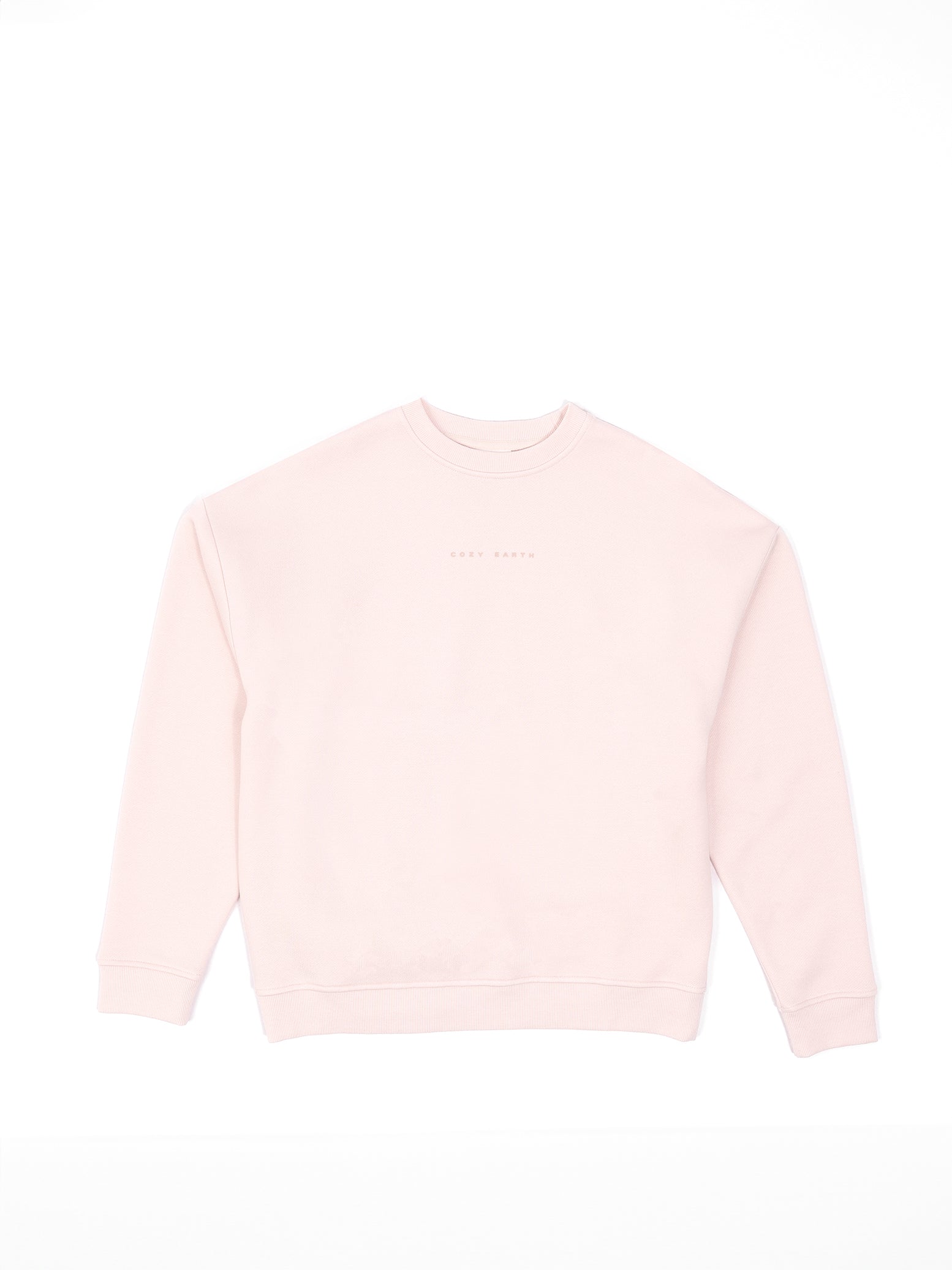 The Women's CityScape Crewneck by Cozy Earth is showcased on a white backdrop. This light pink sweatshirt has a crew neckline and subtle chest text that blends softly with the fabric, making it hard to read. 