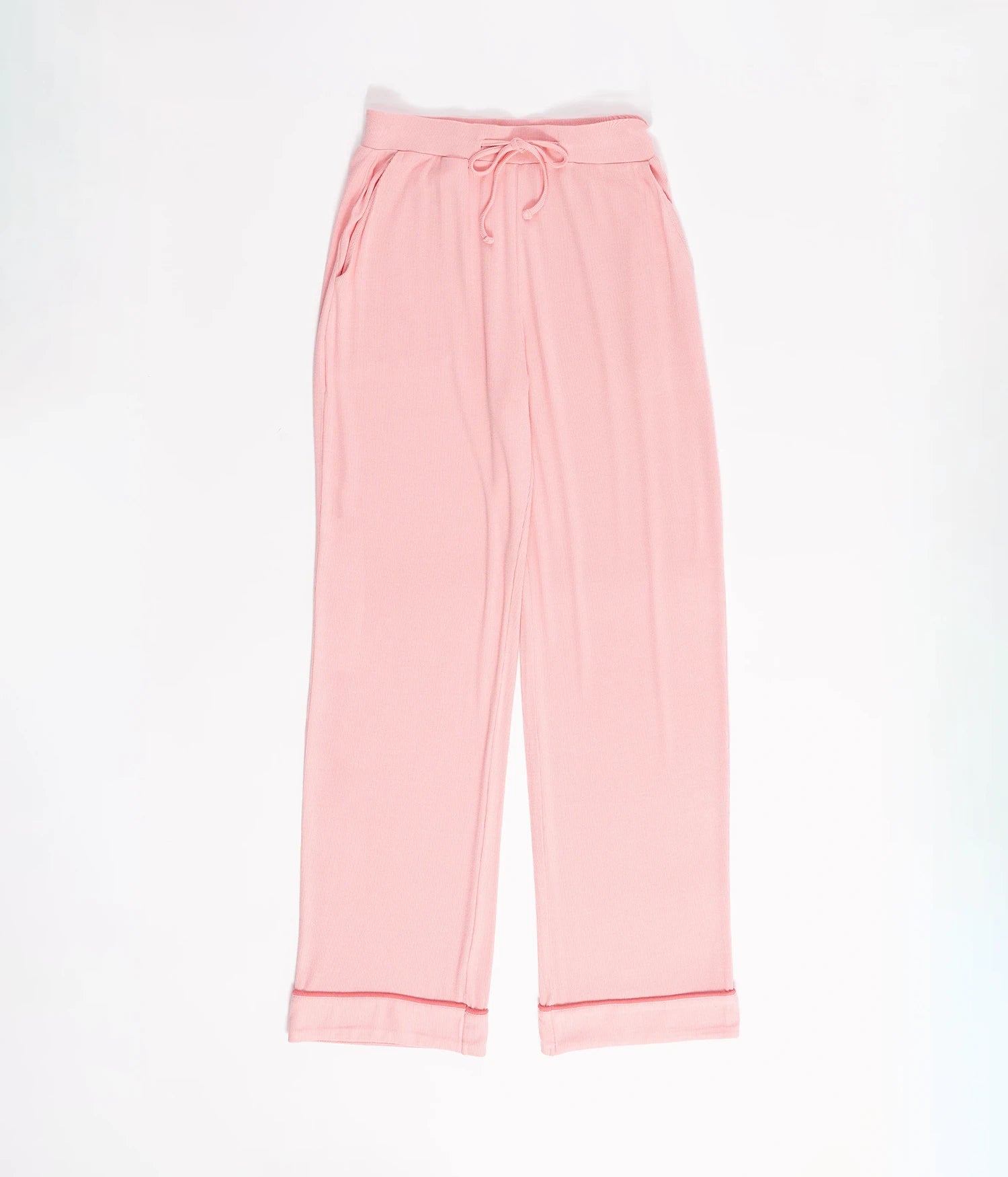 The Rib-Knit Classic Long Sleeve Pajama Set by Cozy Earth features pink lounge pants with a drawstring waistband and cuffed hems. The pants are displayed flat on a white background, highlighting their relaxed, comfortable fit. 