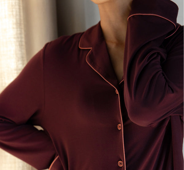Close-up of a burgundy pajama top with a blurred background