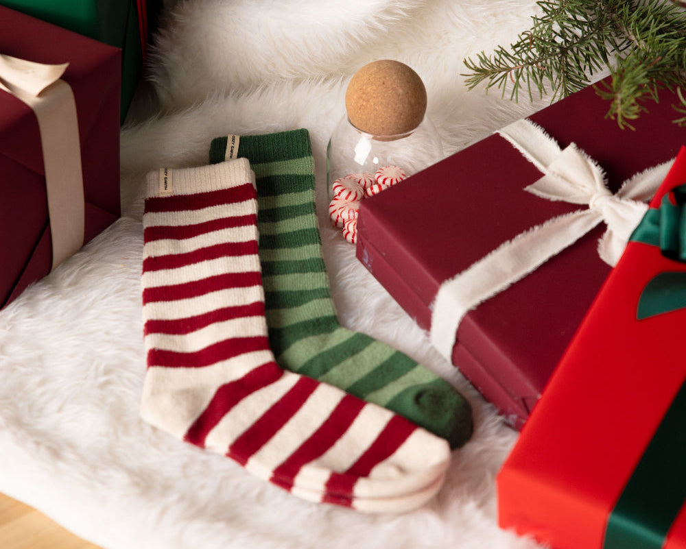 Christmas stockings and presents under a decorated tree