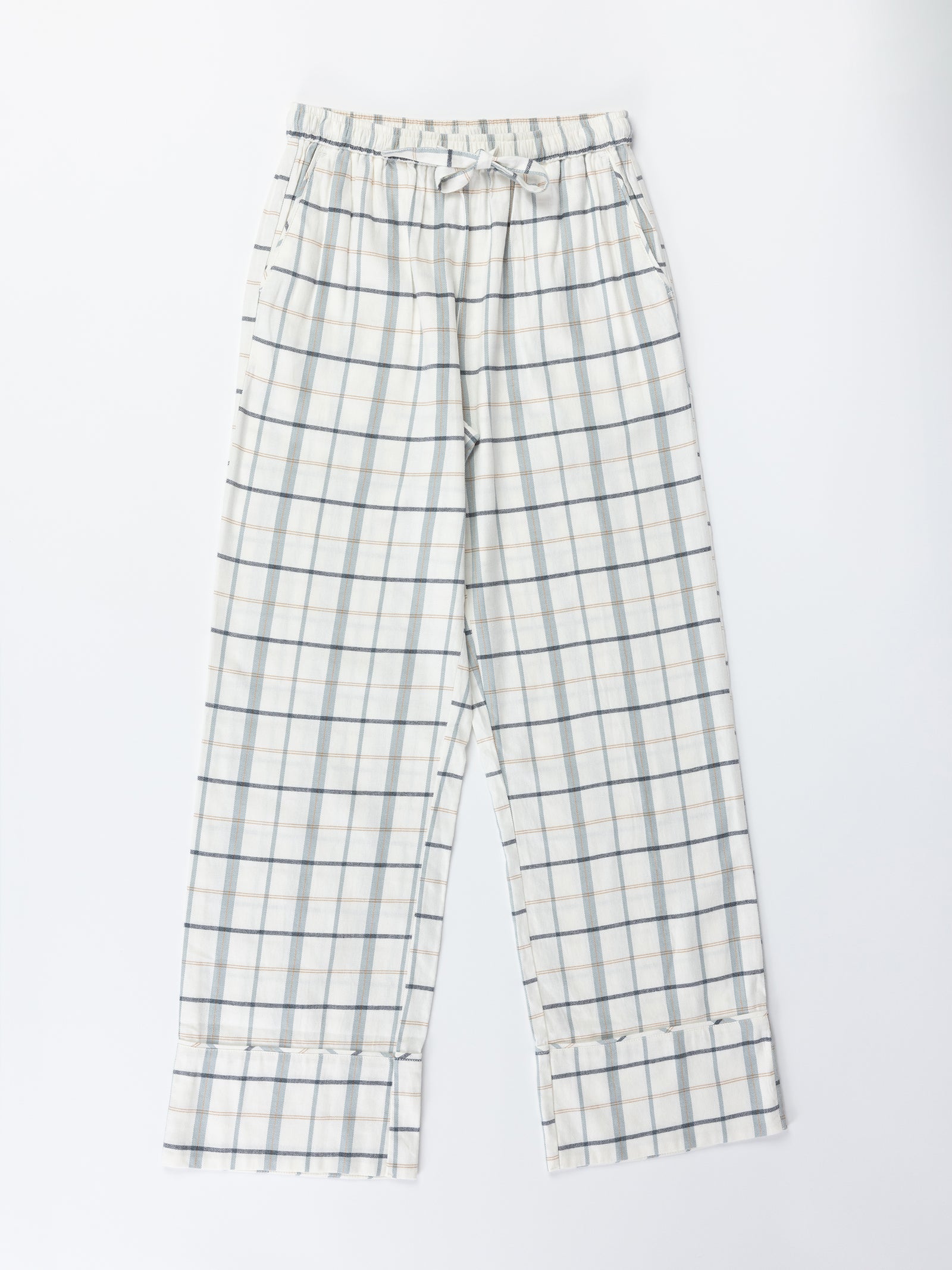 The Women's Farmhouse Pajama Pant by Cozy Earth features a light-colored checkered pattern in white, light blue, and gray. These pajama pants have an elastic waistband and wide, relaxed legs. They are displayed laid flat on a white background. 