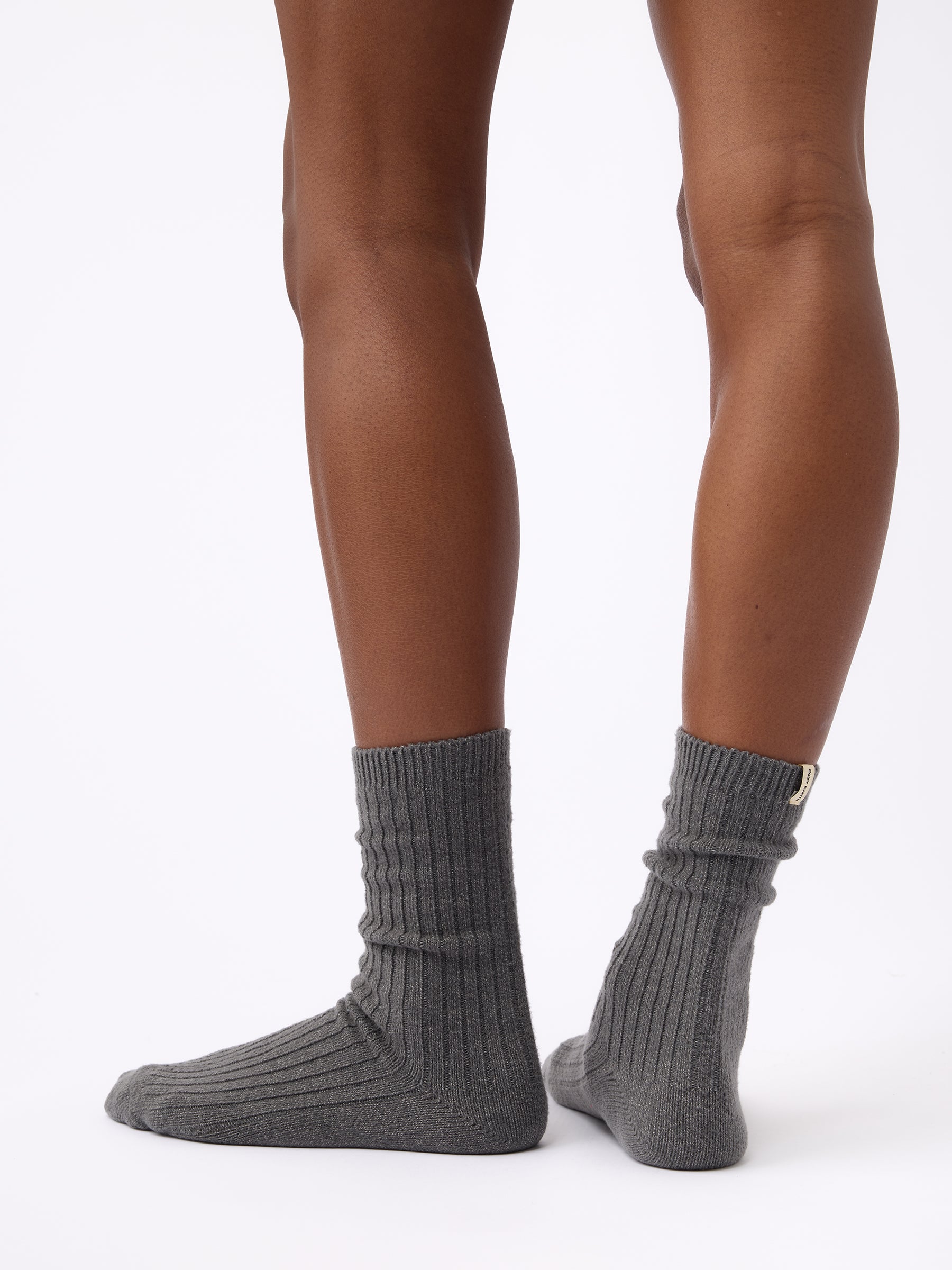Person wearing Cozy Earth Plush Lounge Calf Sock in Coal 