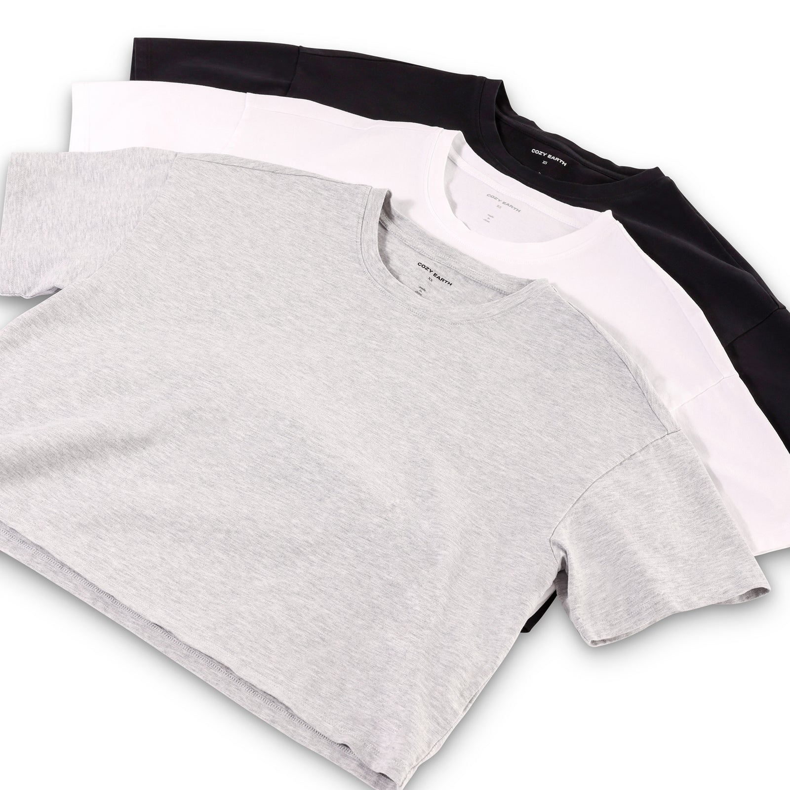 French Dove Heather, Jet Black, and White All Day Cropped Tees laying flat over a white background.