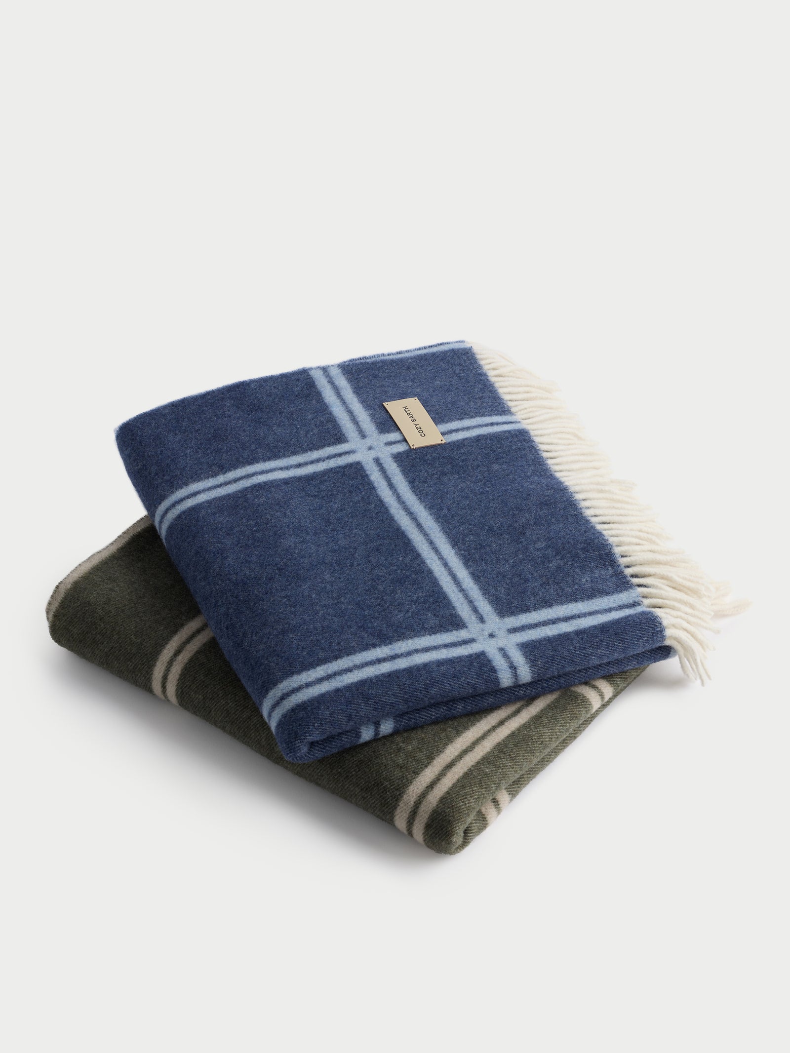 Olive/Beige and Navy/Sky cortina throws folded with white background