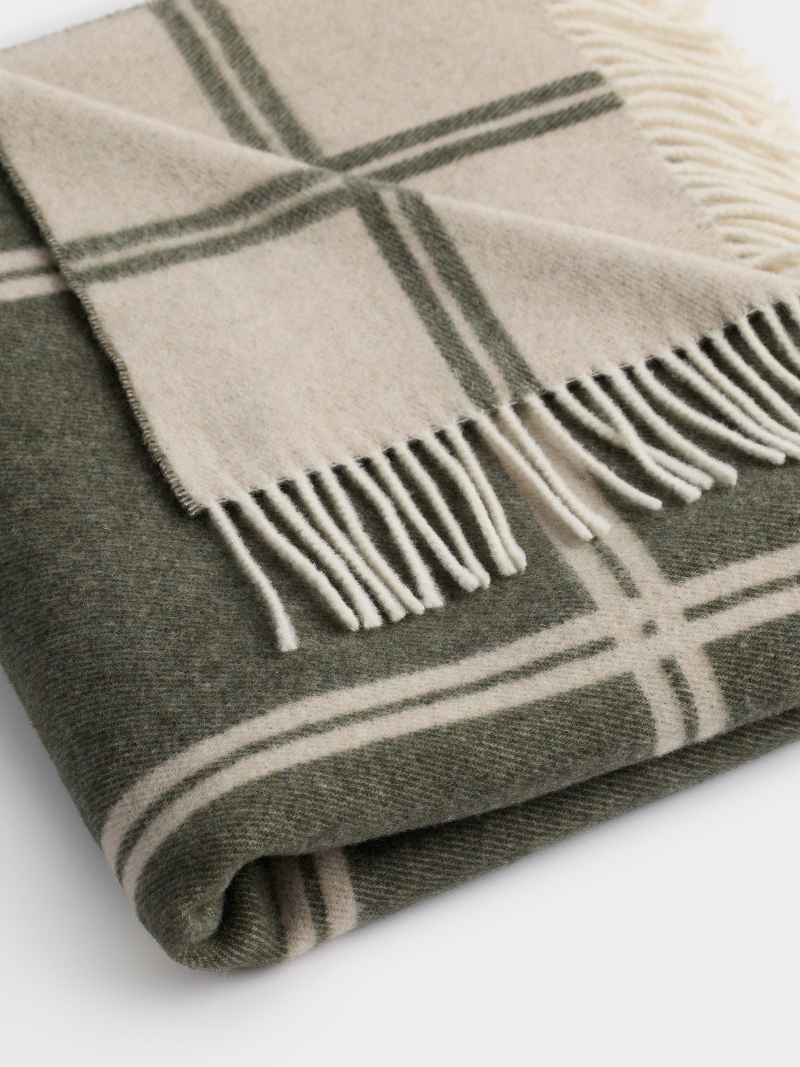 Close up of folded olive cortina throw 