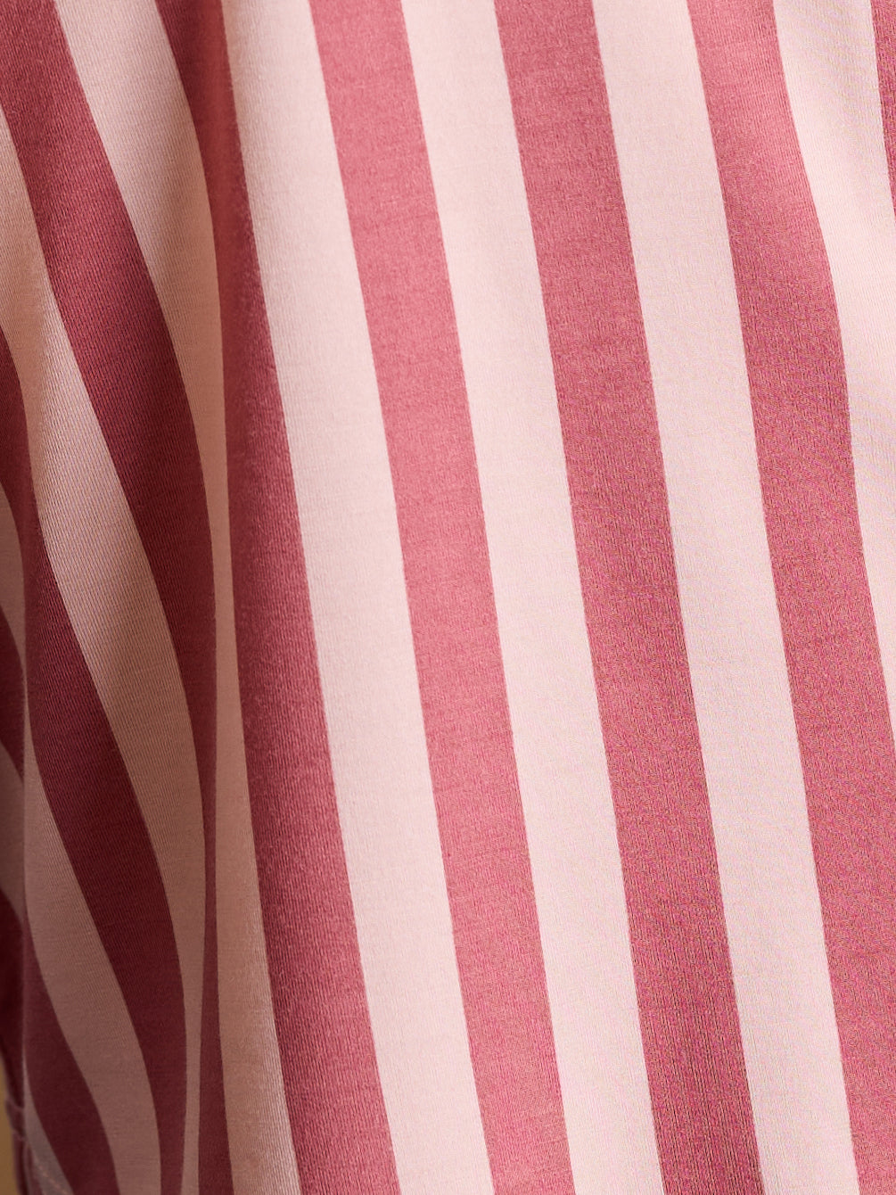 Close up of blush stripe pajama pattern 