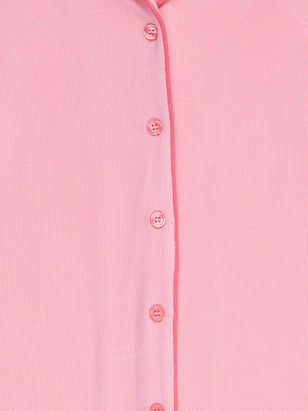 Close-up of Cozy Earth's Women's Bamboo Rib Knit Long Sleeve Pajama Top in pink, featuring a vertical row of matching buttons and a subtle ribbed fabric texture. 