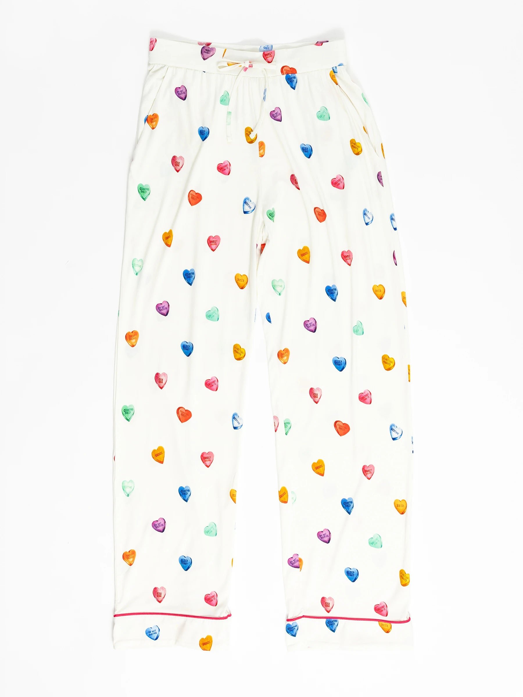 The Women's Stretch-Knit Bamboo Pajama Pant by Cozy Earth features a colorful heart pattern in purple, blue, green, orange, and red on white fabric. They include an elastic waistband and red piping at the cuffs. 
