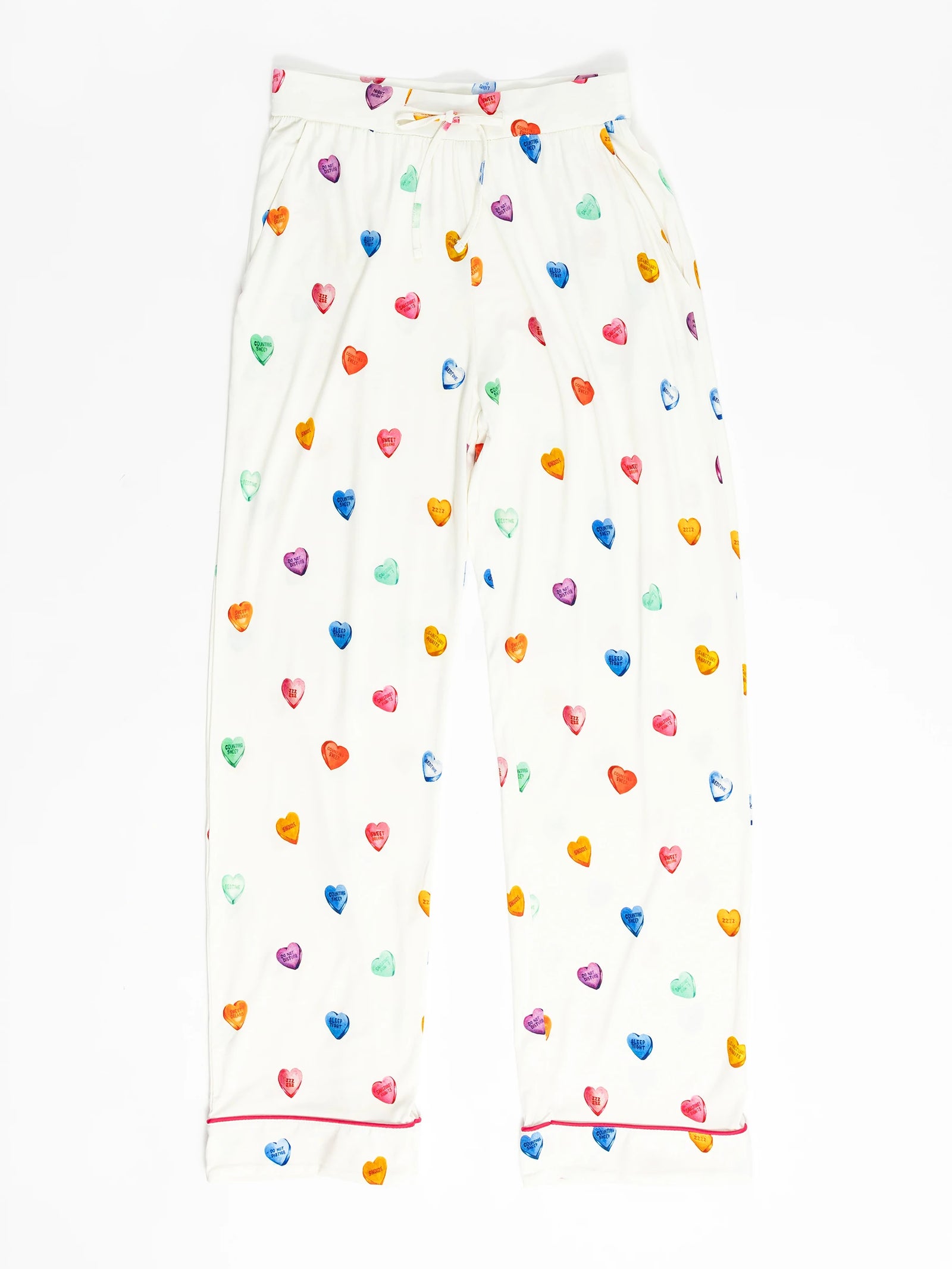 The Women's Stretch-Knit Bamboo Pajama Pant by Cozy Earth features a colorful heart pattern in purple, blue, green, orange, and red on white fabric. They include an elastic waistband and red piping at the cuffs. 