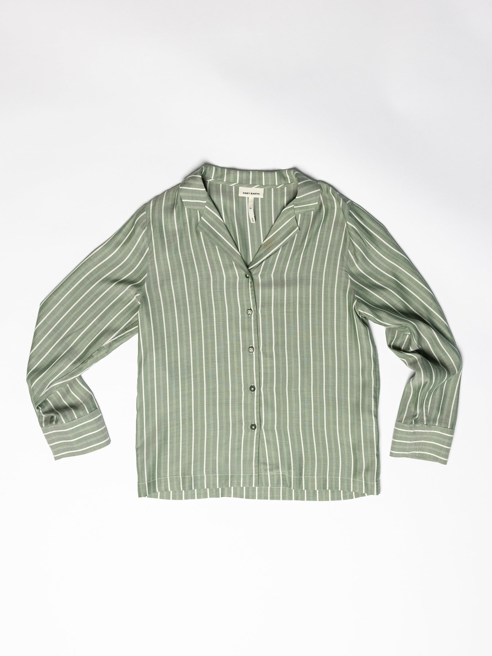 An image showcases the Women's Soft Woven Long Sleeve Pajama Top by Cozy Earth, a green shirt adorned with white vertical stripes, complete with a collar and button-down design, set against a plain white background. 