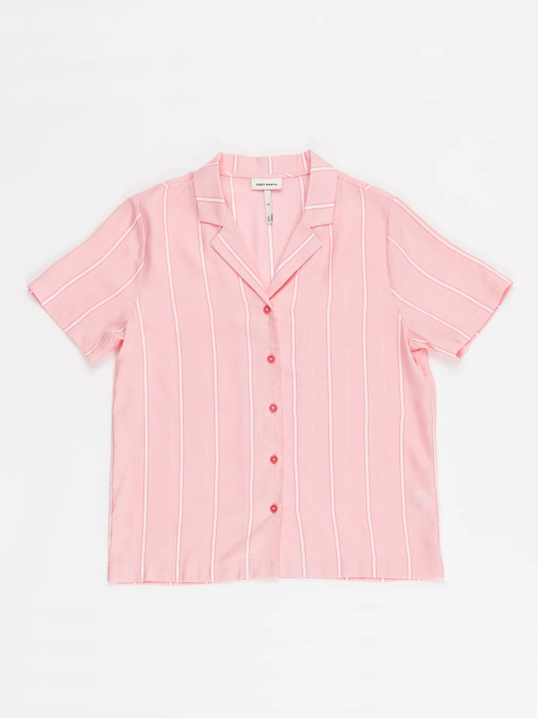 A short-sleeved Women's Soft Woven Pajama Top by Cozy Earth in pink with vertical white stripes and five pink buttons down the front, is laid flat on a white background. 