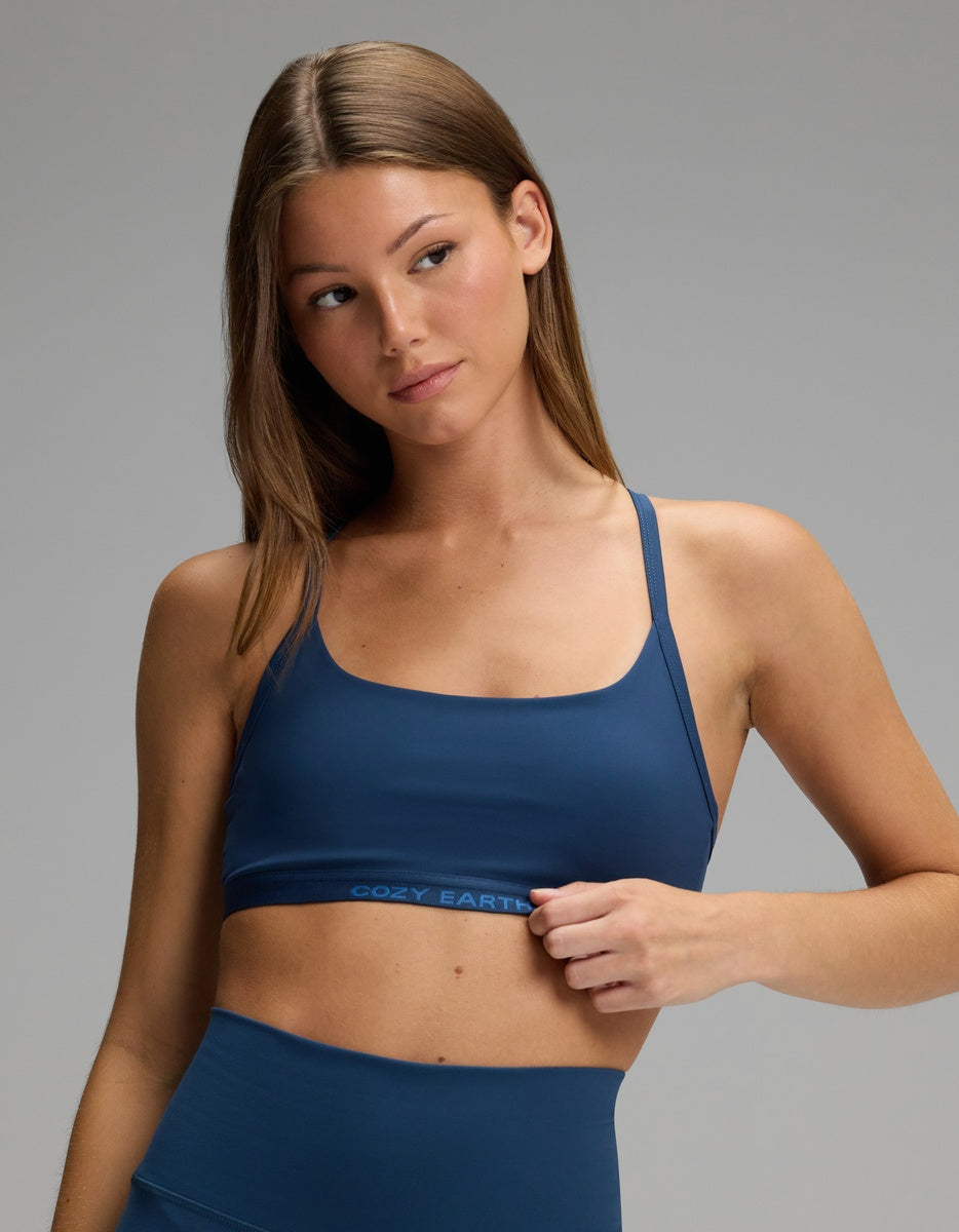 A woman wearing a dark blue Cozy Earth Women’s Balance Bra with thin straps and a branded elastic band.