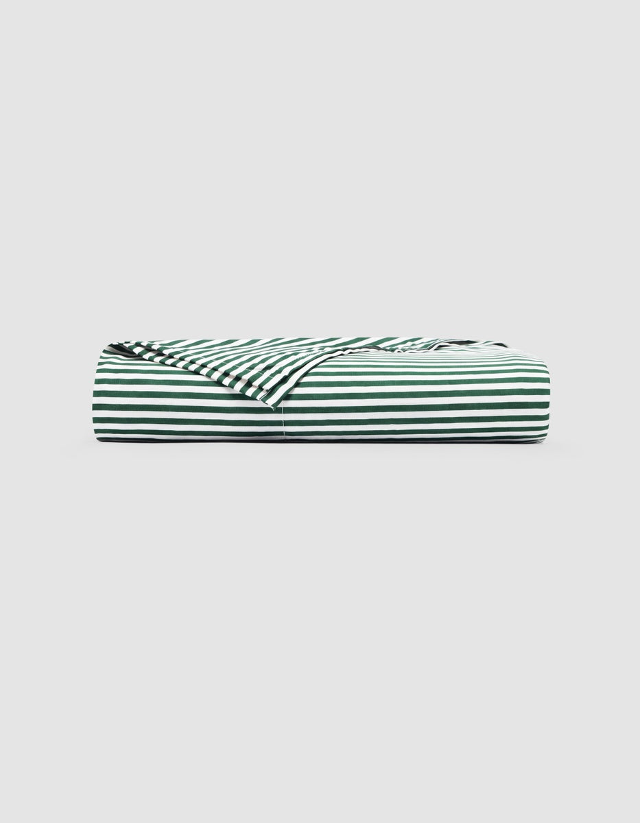 A Cozy Earth Bamboo Flat Sheet folded flat with a pattern of dark green and white horizontal stripes.