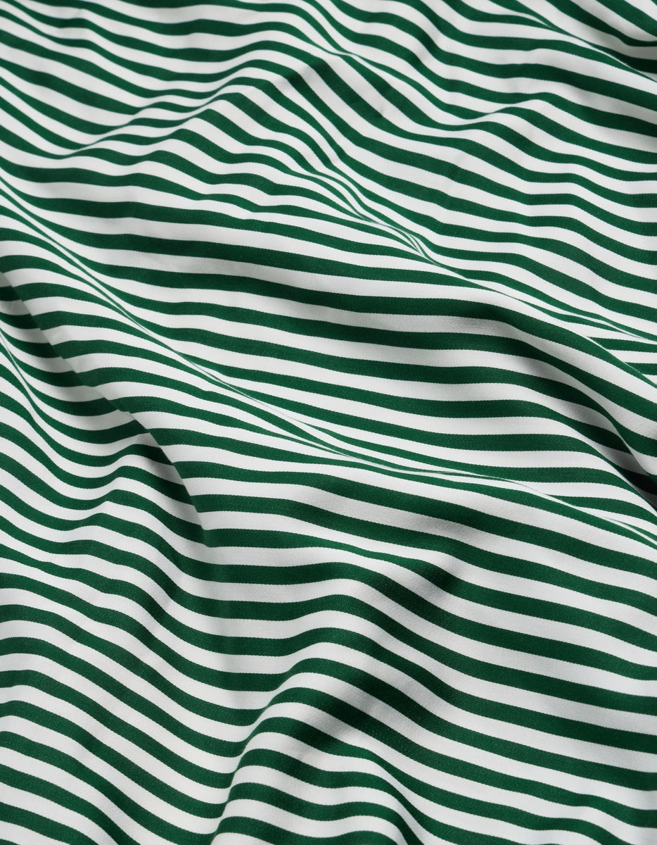 Cozy Earth Bamboo Flat Sheet in a pattern of horizontal dark green and white stripes, shown in soft folds.