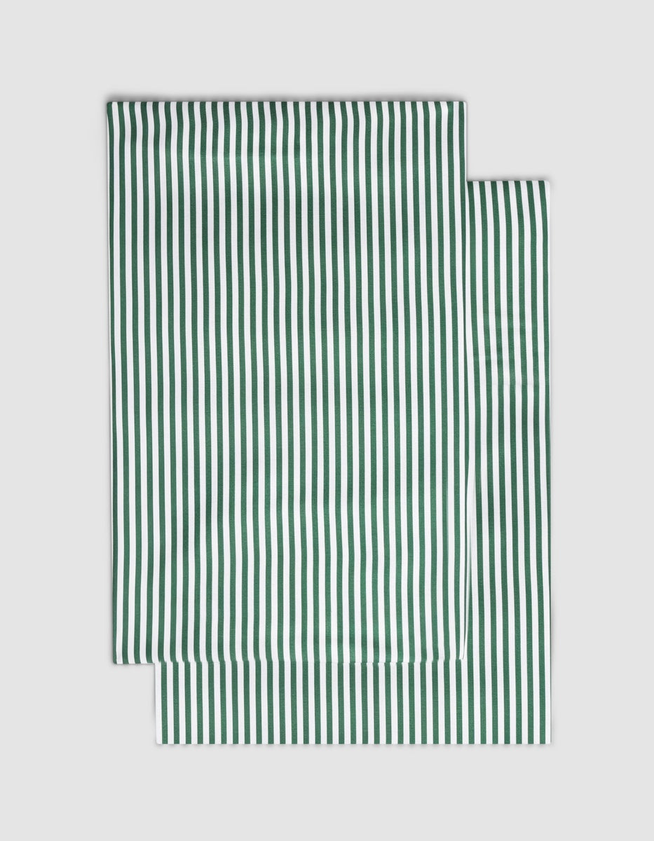 Two rectangular Bamboo Pillowcases by Cozy Earth featuring a white and dark green vertical striped pattern.