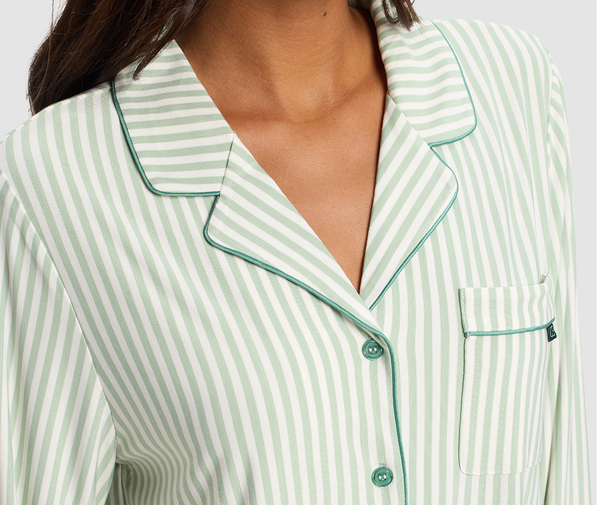 Green and white striped pajama top with a close-up view.