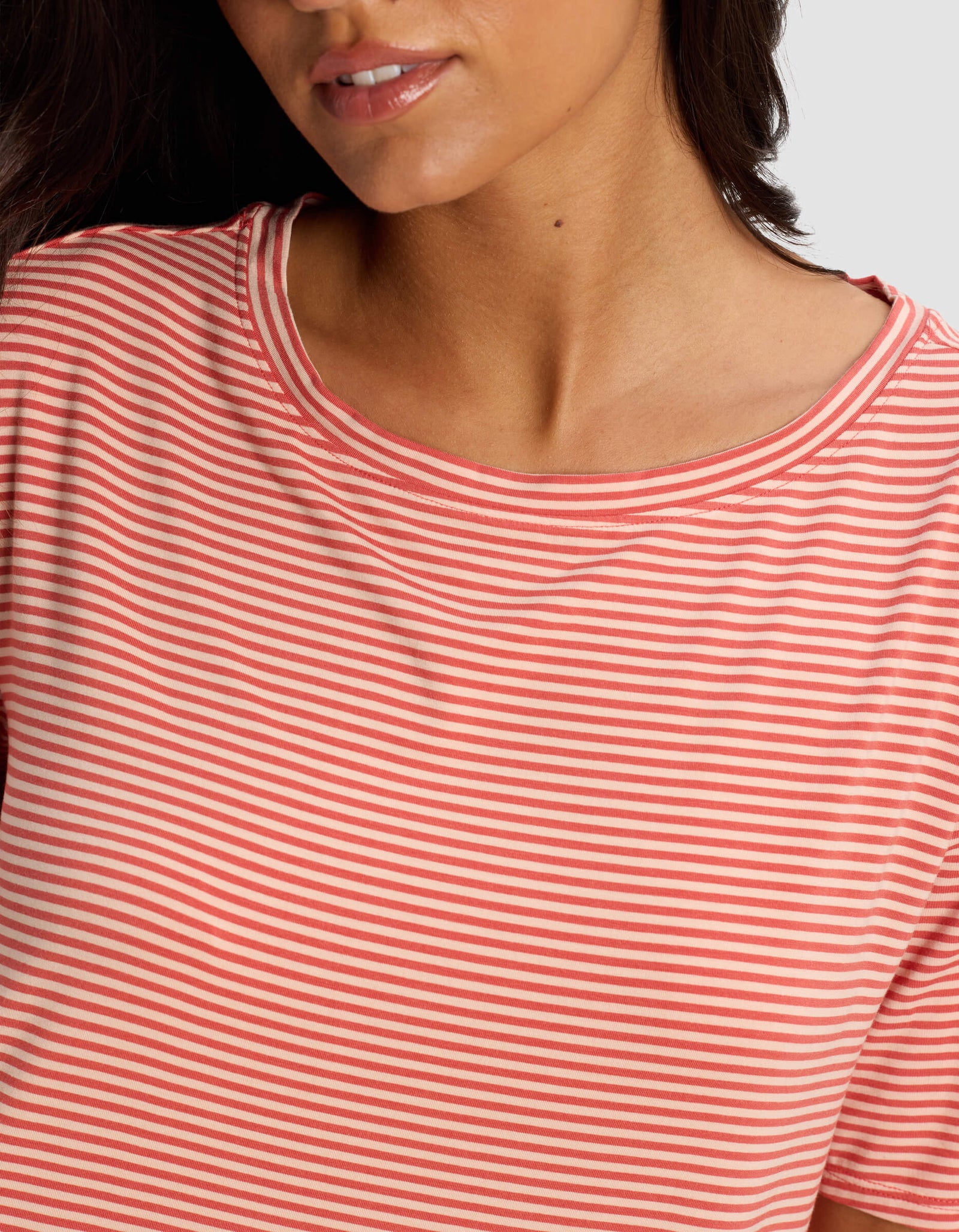 A woman models the Cozy Earth Women's Bamboo Stretch Knit Sleep Dress, shown from the shoulders up with her head slightly turned and only the lower half of her face visible.