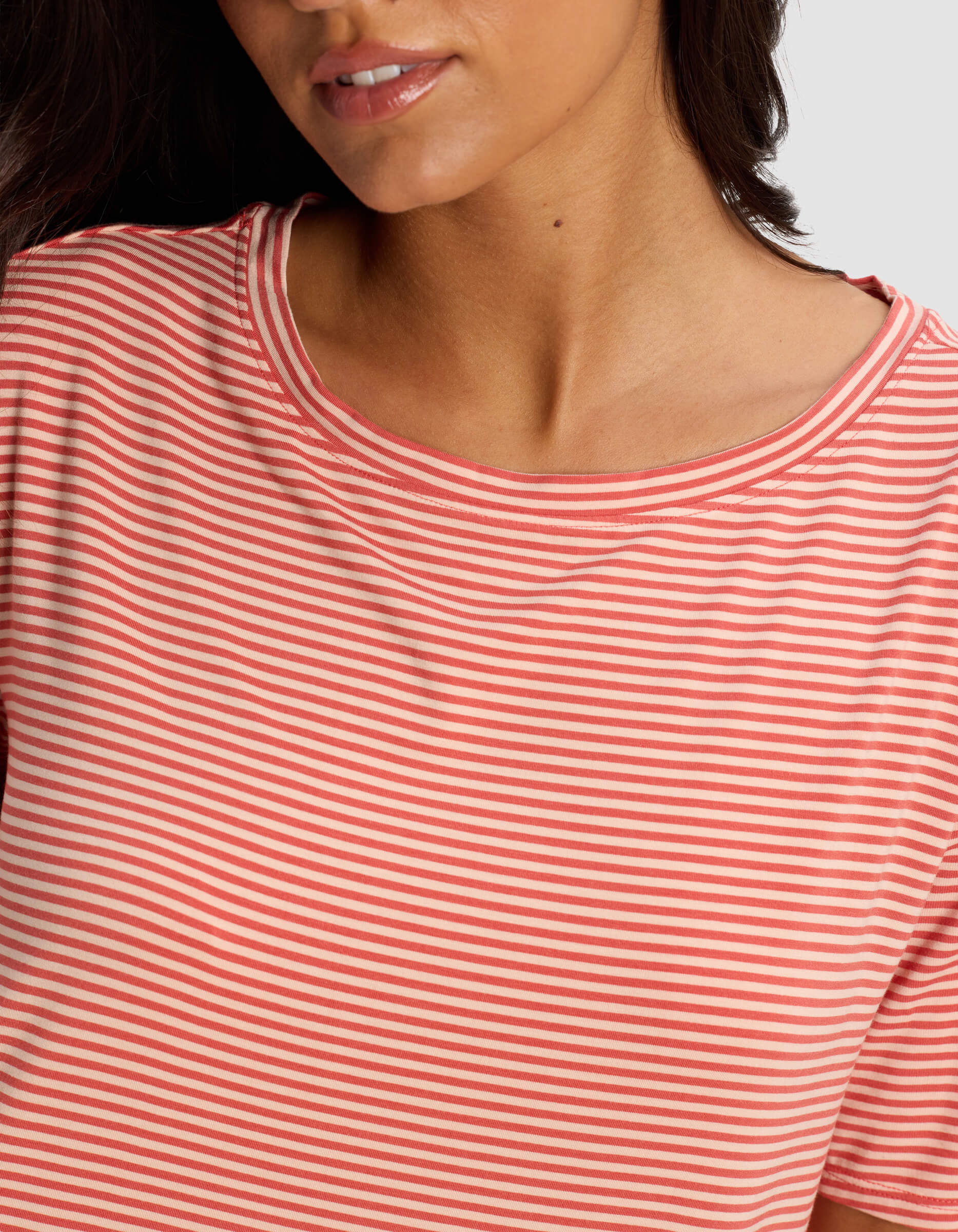 A woman models the Cozy Earth Women's Bamboo Stretch Knit Sleep Dress, shown from the shoulders up with her head slightly turned and only the lower half of her face visible.