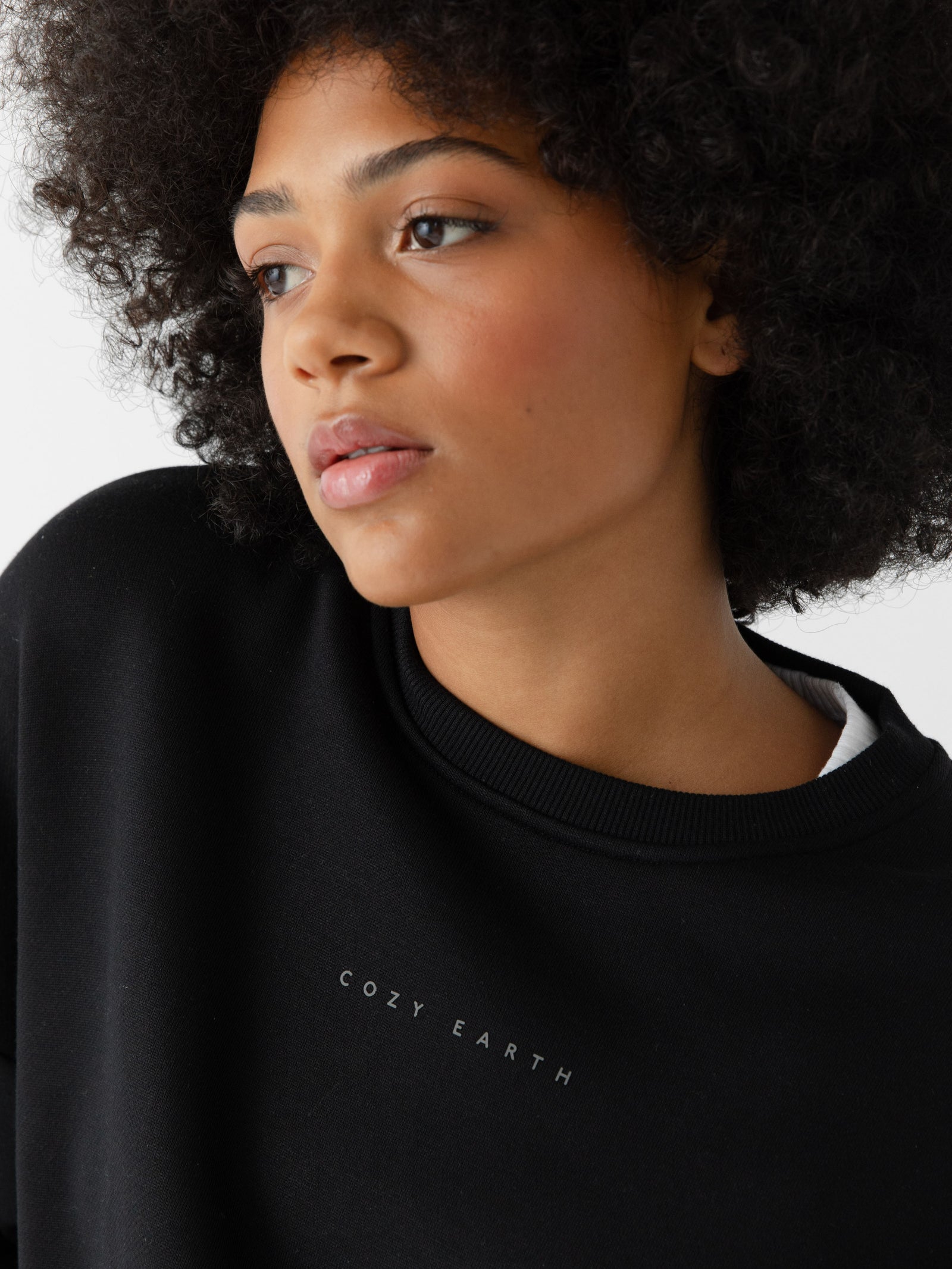 Black CityScape Pullover Crew. The Pullover is being worn by a female model. The photo was taken with a white background. 